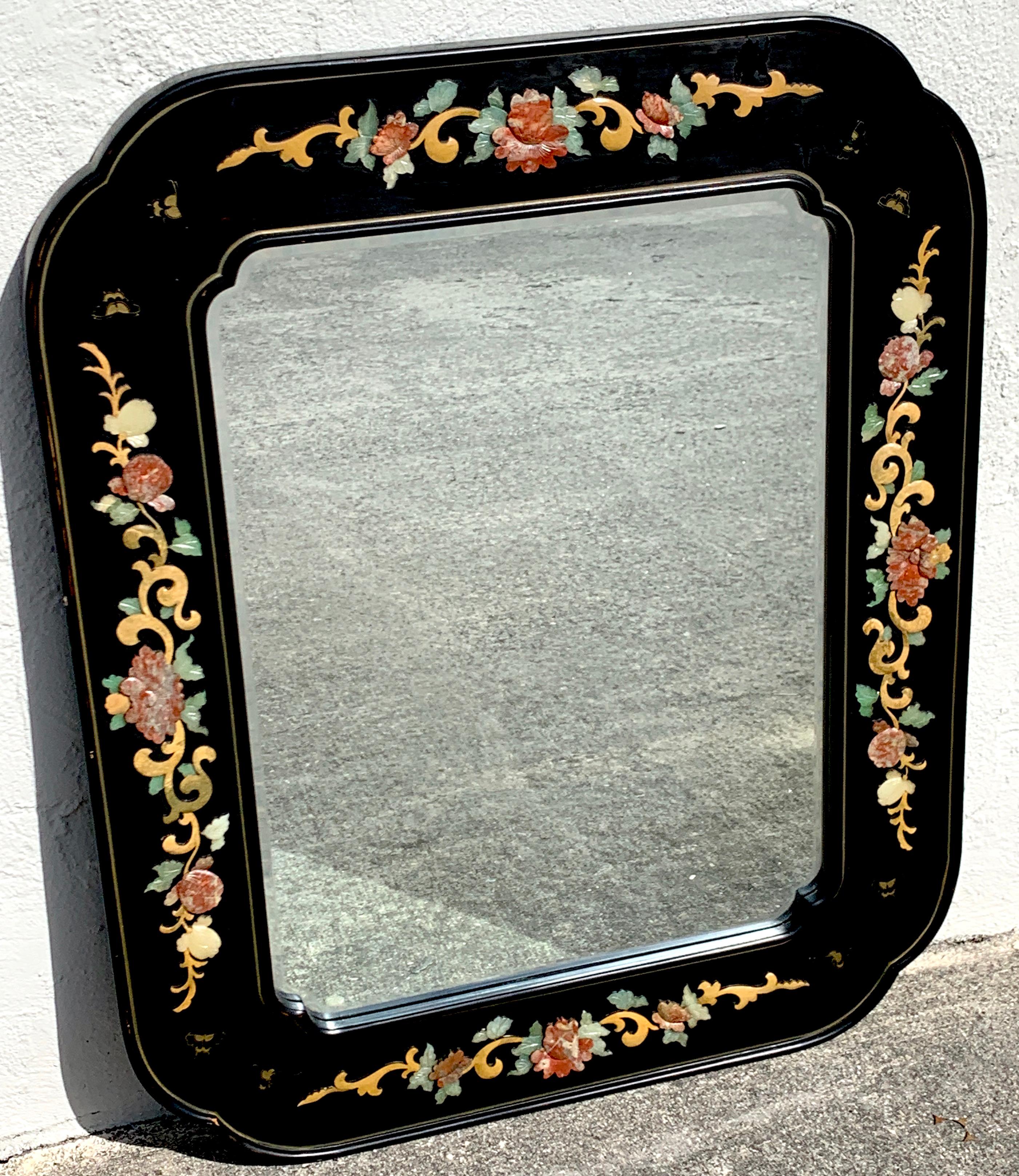 Chinese export lacquer and hardstone mirror, with various hardstone floral inlays in a gilt lacquer cartouche frame. The inset mirror is 22