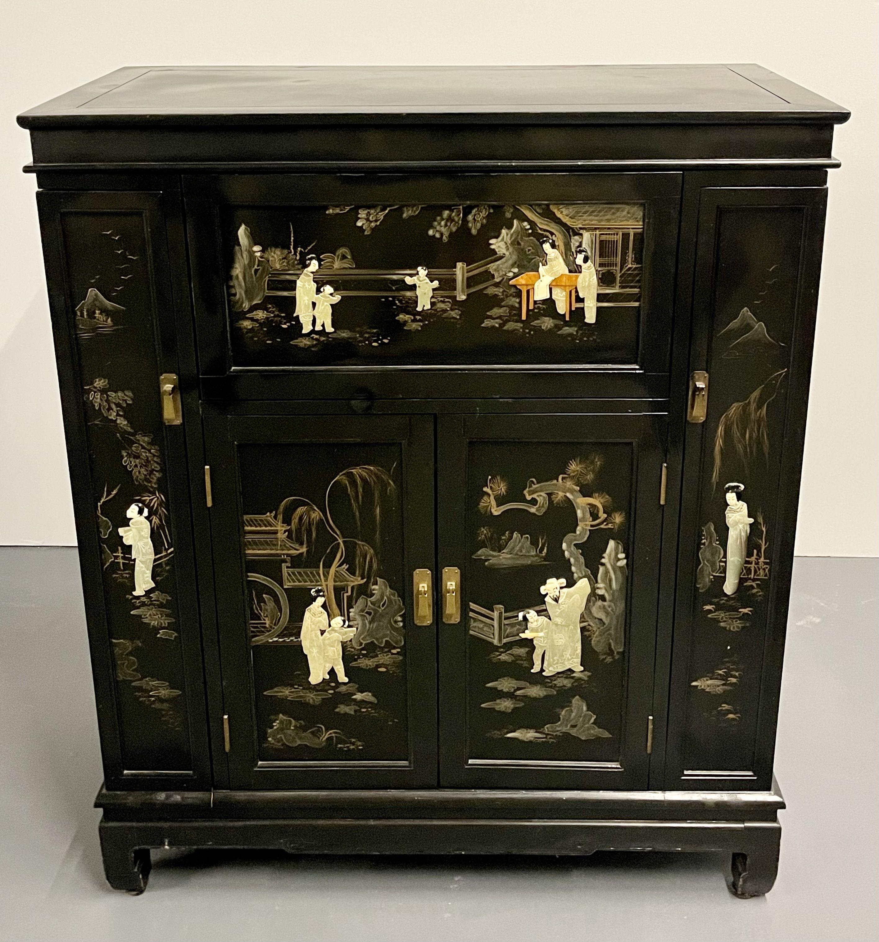 Chinese Export lacquered bar. Ebony Raised Figure Carvings with Pearl and Jade colors in the Chinoiserie Fashion. This finely and highly functional bar has a lever adjustable bottle tray and pull out lower bottle shelf. The case having two large