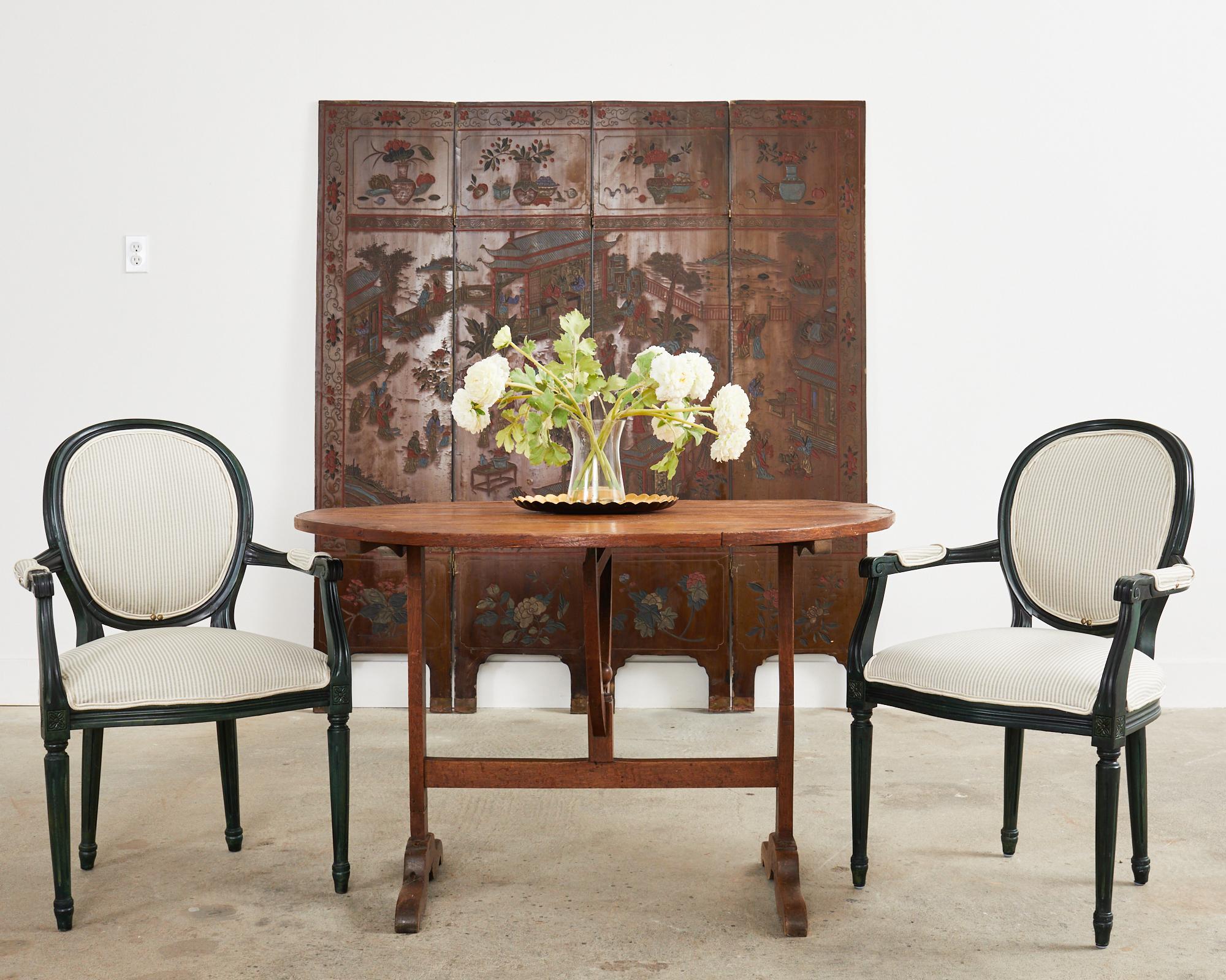 Beautifully weathered Chinese export four-panel coromandel screen decorated on both sides. The screen features a pavilion landscape on one side and a floral and fauna landscape on the reverse side. The panels are lacquered and faded with a desirable