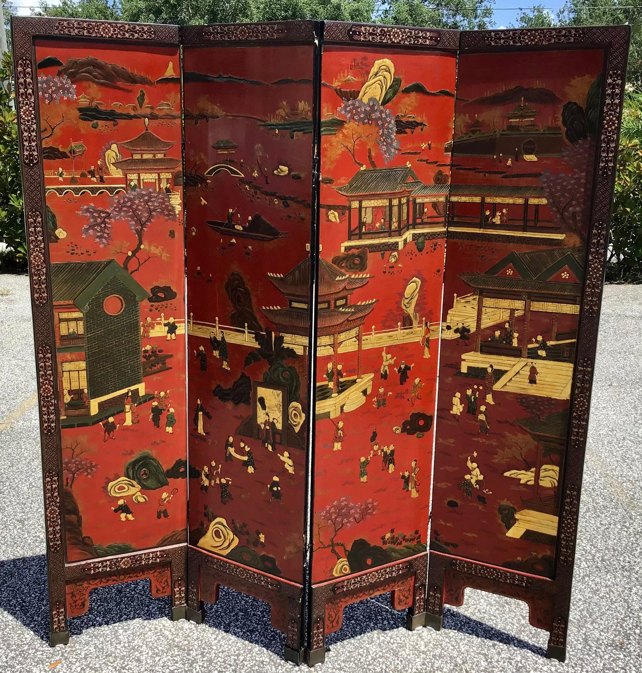 Remarkable Chinese export 4 panel coromandel screen. Red ground and parcel gilt decorated landscape scene. The idyllic painting is crafted with intricate details and a geometric border. The reverse side features a parcel gilt with a black lacquer