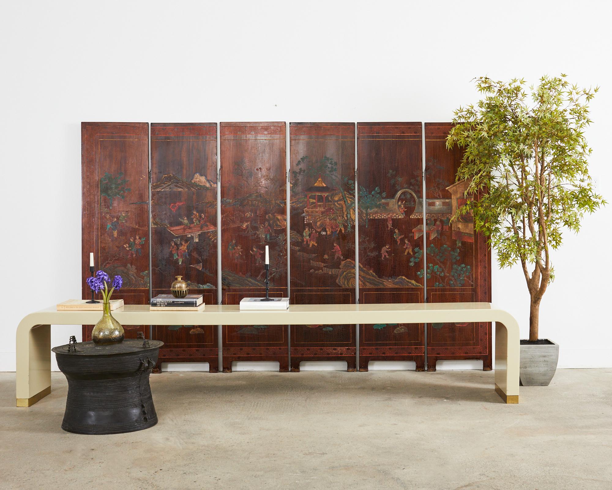 Beautifully weathered patina Chinese export lacquered coromandel screen with six double sided panels. The screen features a mountain landscape on one side and an idyllic pavilion landscape on the other. The pavilion scene features a fertility style