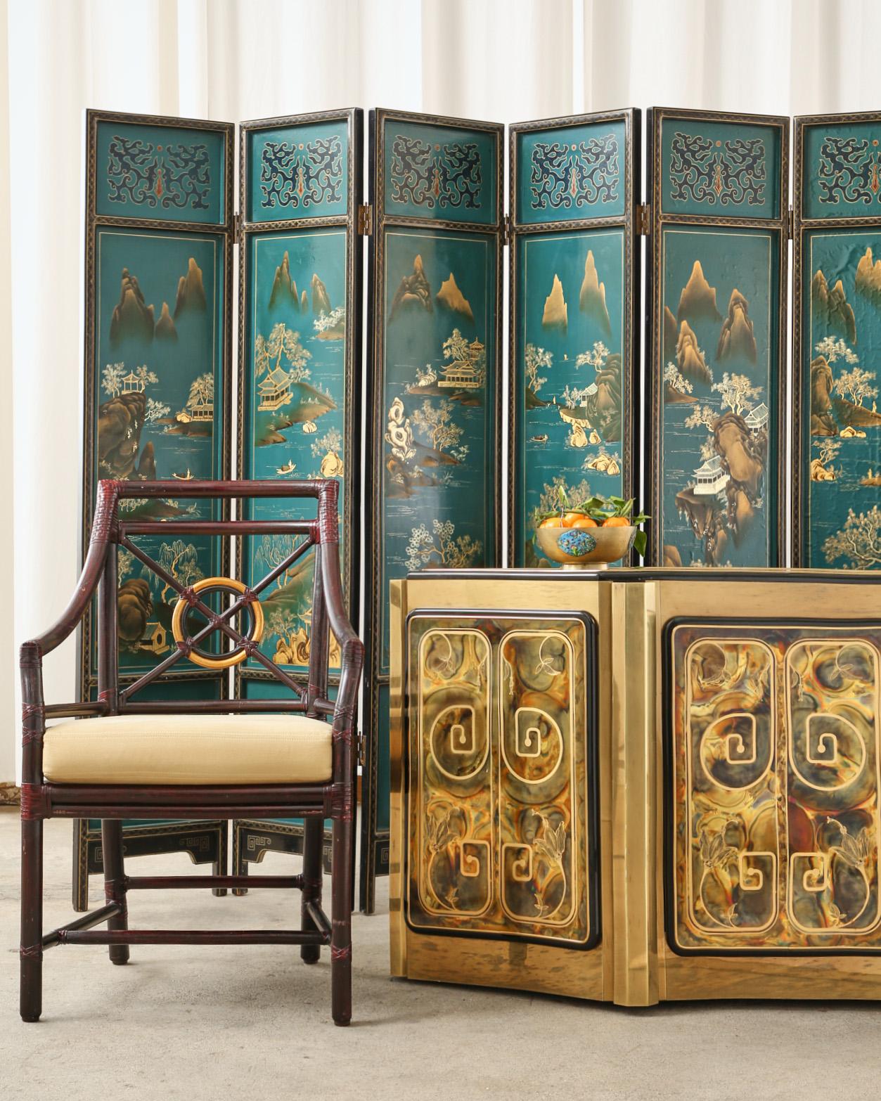 Charming Chinese export six-panel lacquered coromandel screen featuring idyllic painted mountain landscape scenes over a dramatic turquoise ground. The lacquered wood panels are inset with the painted scenes and have a geometric gilt border trim.