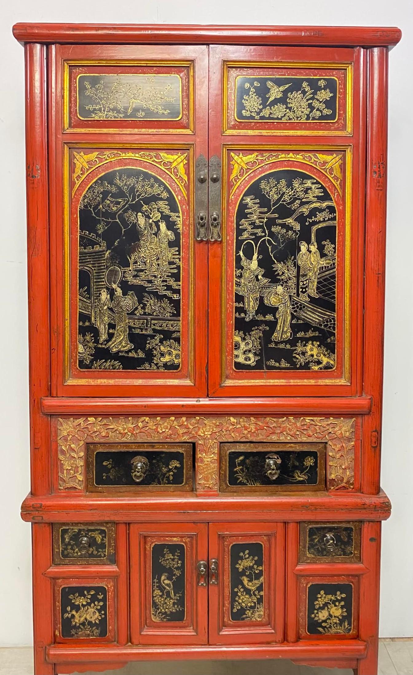 Elegant Chinese two-piece lacquered cabinet finished in red lacquer with black lacquer front doors and drawers. Features idyllic painted figures within a landscape scenes on the front and floral foliate bird scenes. The center two drawers bordered