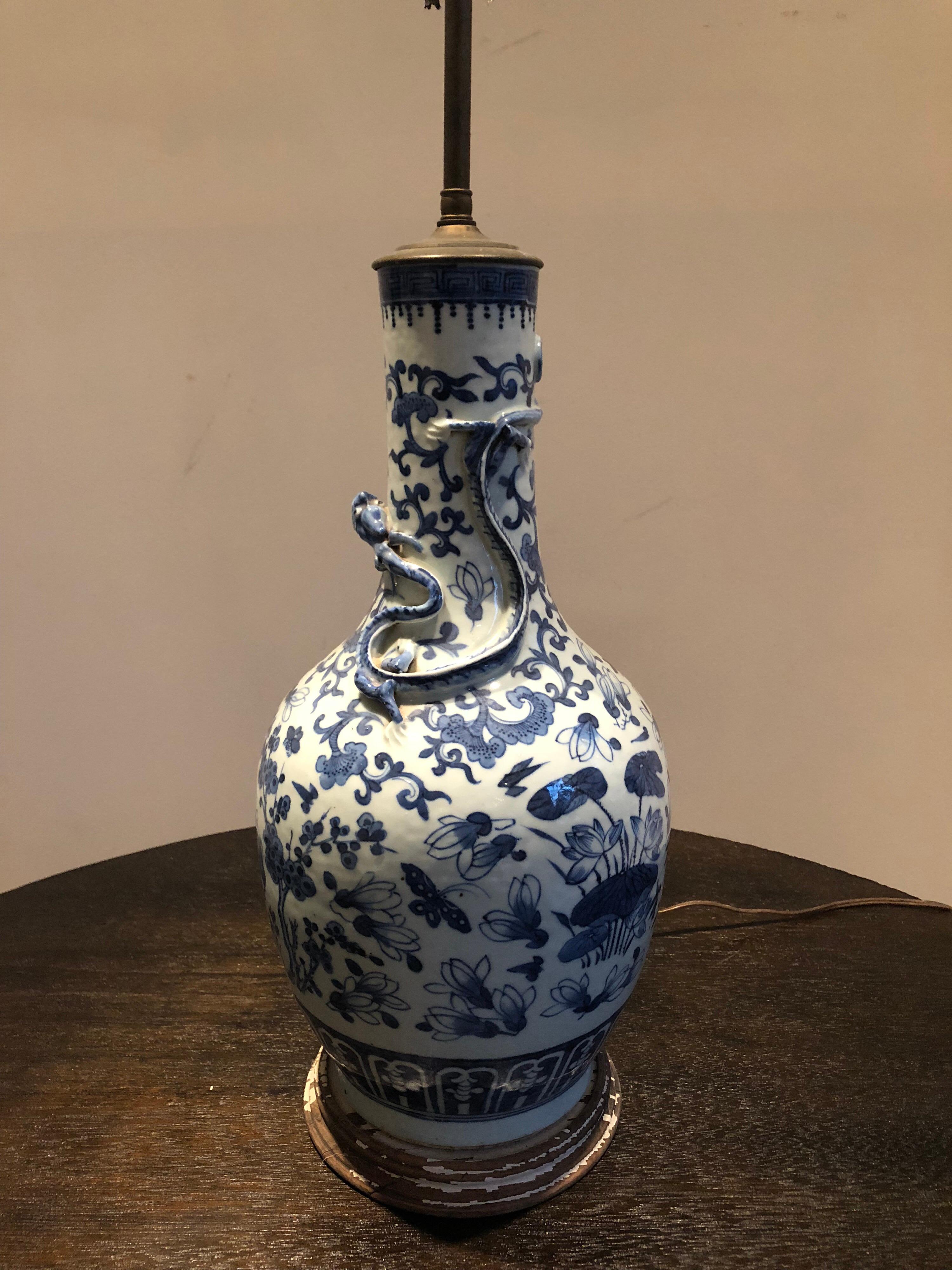 Vase d'exportation chinois à motifs bleus et blancs, transformé en lampe. Intéressant détail de dragon en relief. Base peinte en Distress. Deux prises de courant. L'abat-jour est utilisé à des fins de présentation uniquement. Le vase mesure 19 