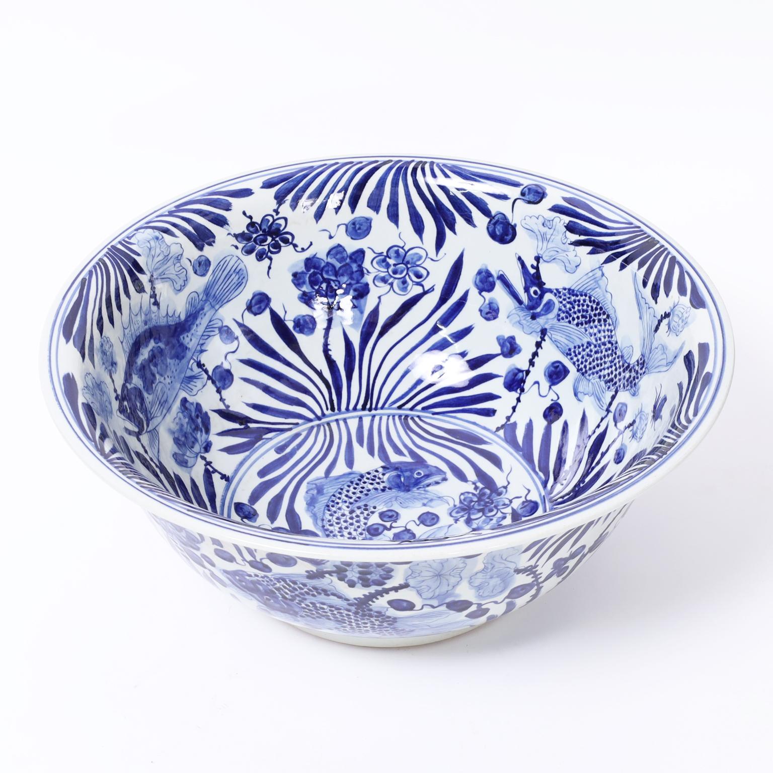 Lofty large Chinese blue and white bowl hand decorated with aquatic fauna and flora having a rare touch of whimsy. 