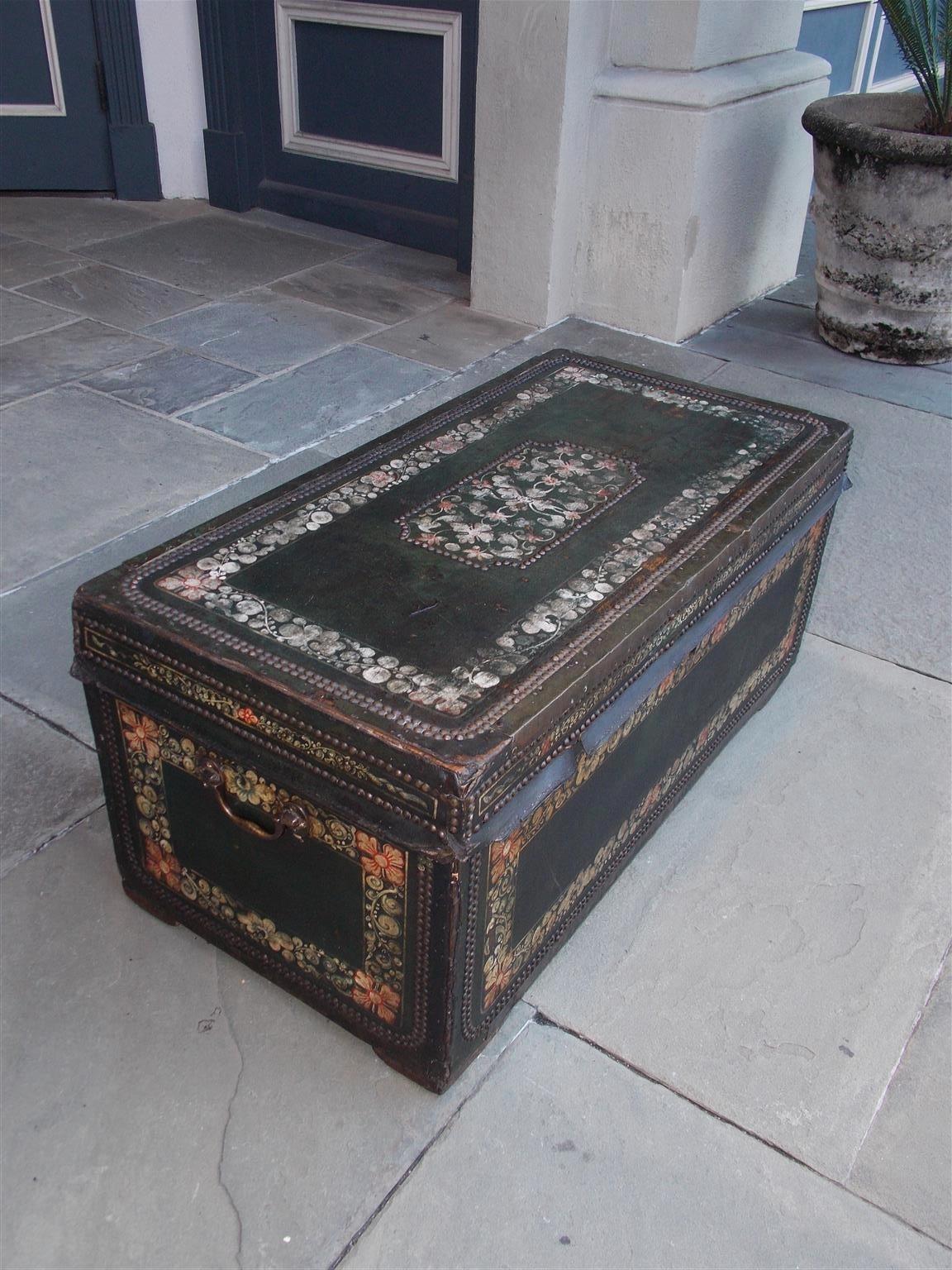 Chinese export leather clad polychrome and painted camphor wood trunk with flanking side handles and brass nail head trim.  Early 19th century.