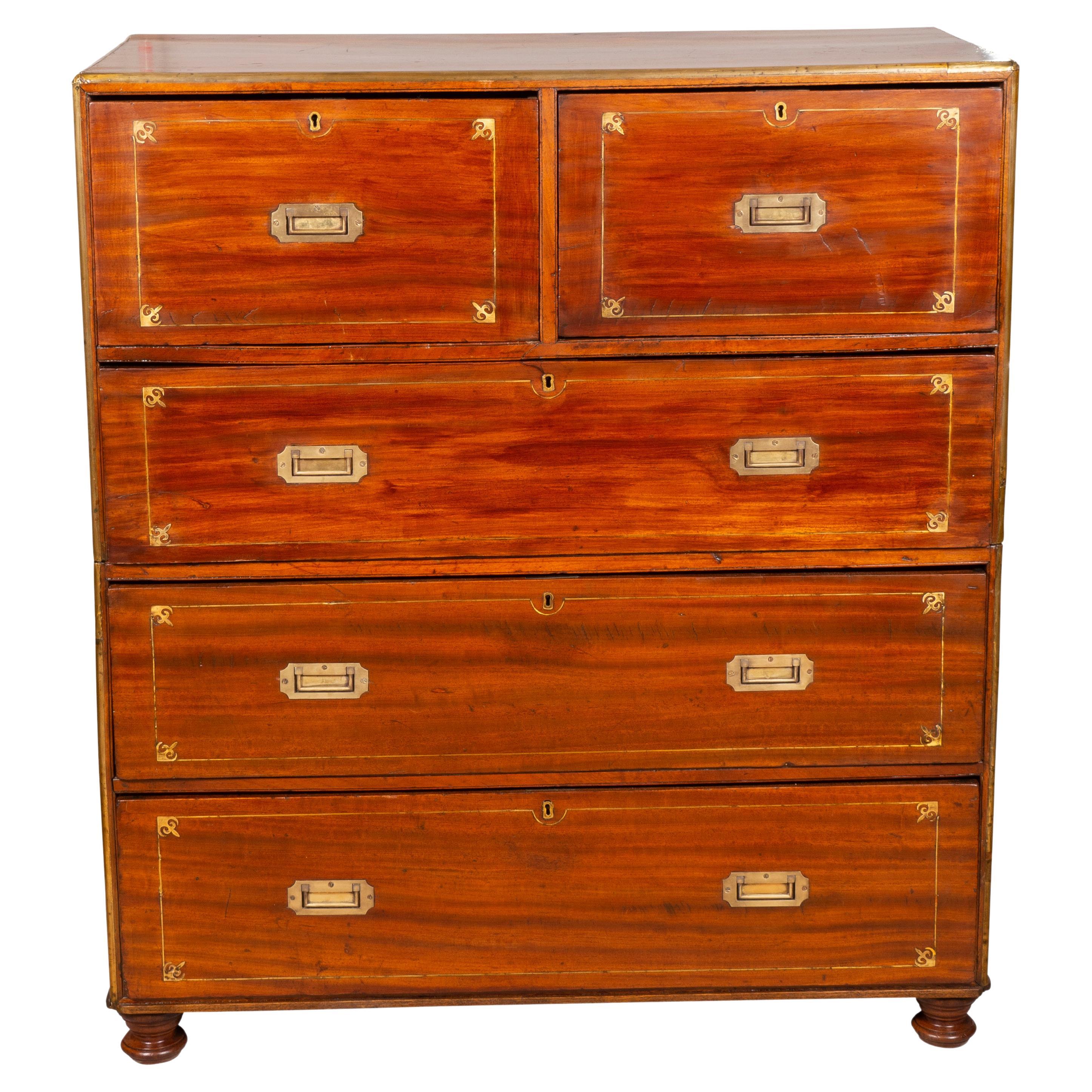 Unusually large with a rectangular top with brass edge which continues throughout the whole case. Two drawers over three long drawers all with brass inlay and recessed handles, original toupee feet. In two parts with side bail handles.