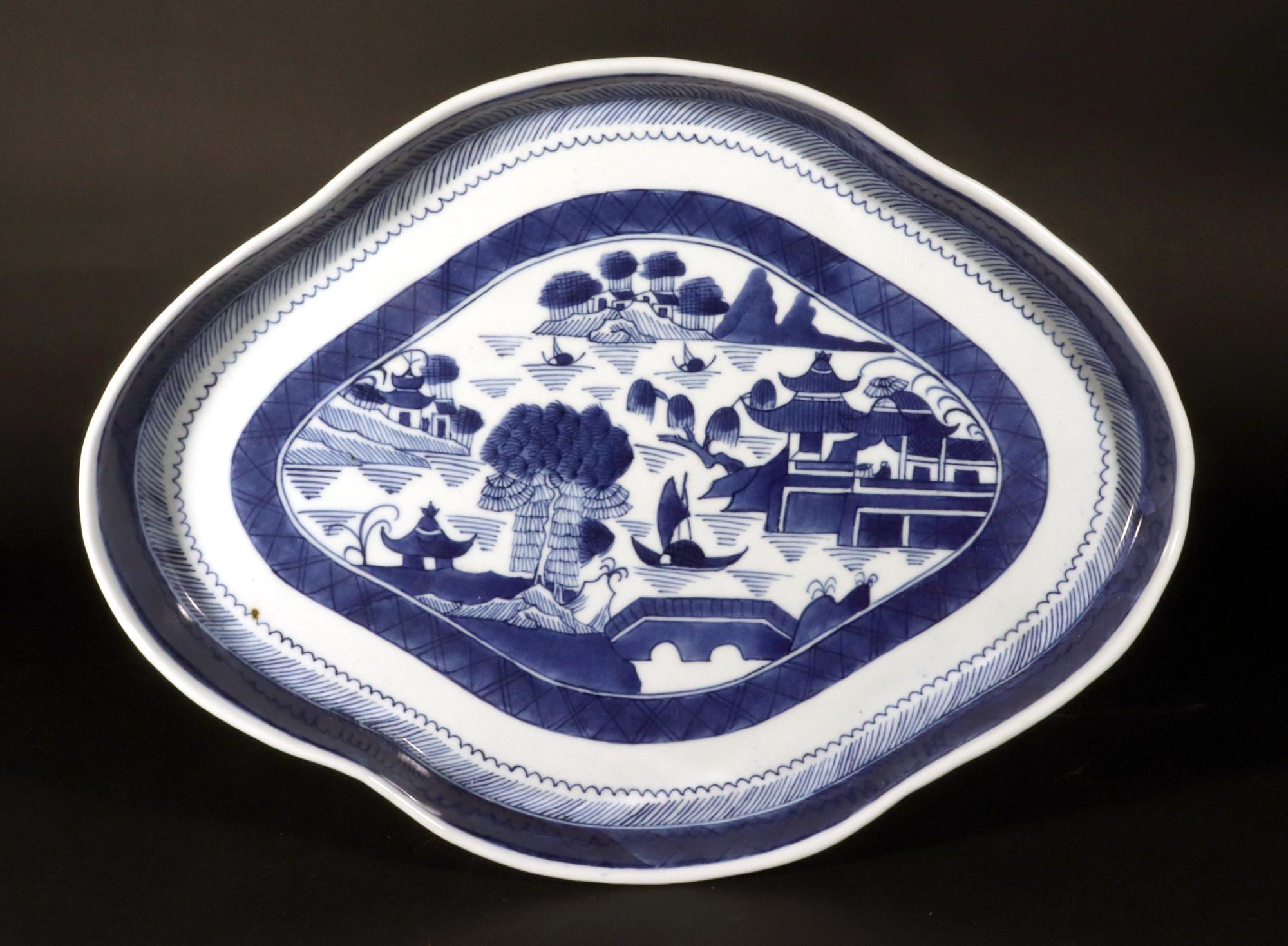 Chinese Export Canton Nankin Blue & White Porcelain Tray,
Circa 1810-20

The oval large Chinese Nankin porcelain oval tray is decorated in underglaze blue and white with a riverscape scene of islands with buildings sand trees with ships sailing on
