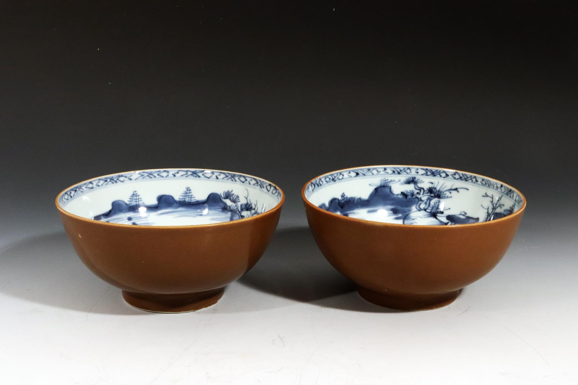 Nanking Cargo Chinese Export Porcelain Cafe au Lait and Blue Pair Bowls

The Chinese Export porcelain bowls are painted with a Cafe au Lait, Batavia-ware brown ground. The interiors are painted in underglaze blue with a wide scene that covers