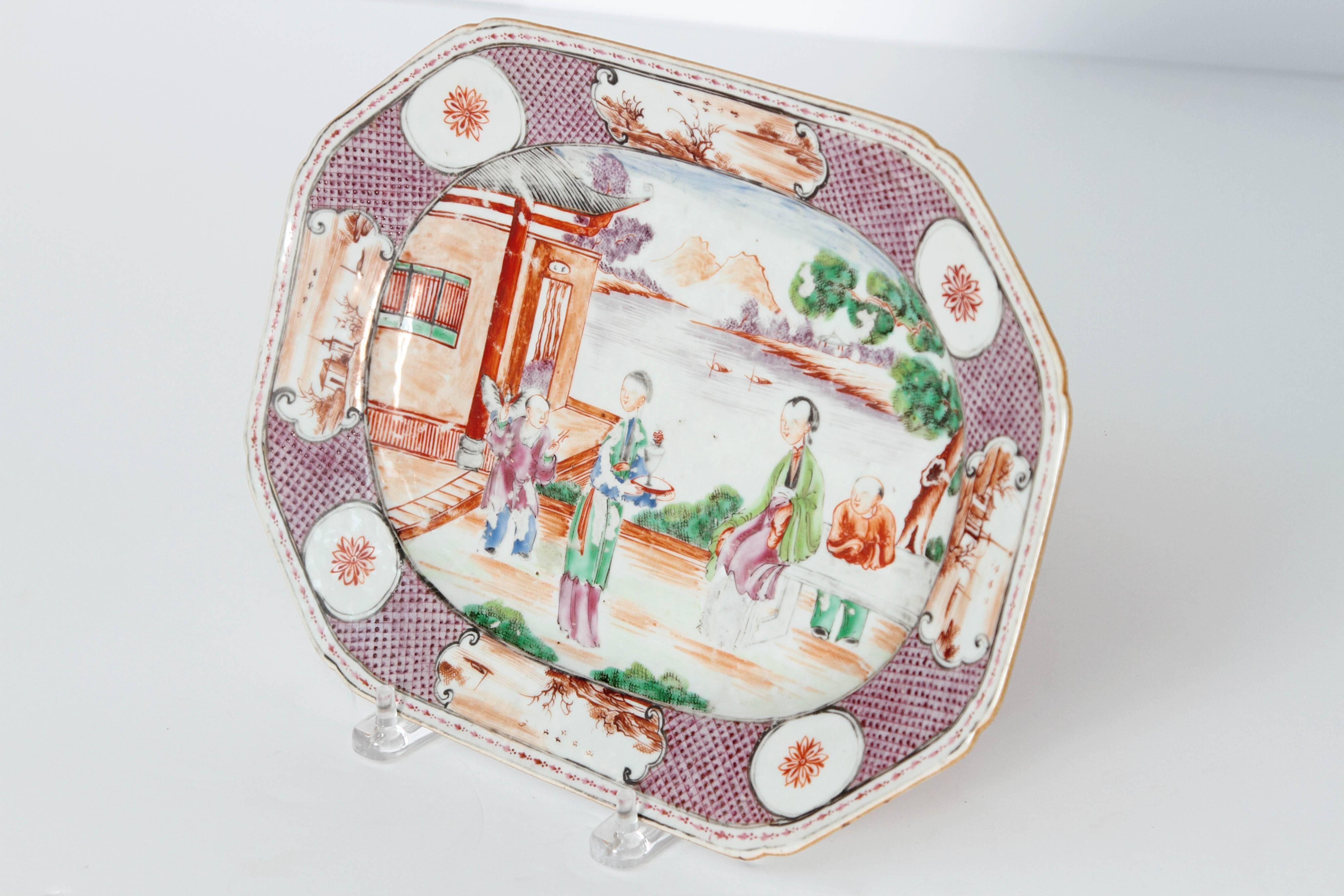 Chinese Manderin palette medium size platter. Center with famille rose women and children in courtyard. Border with small vignettes.