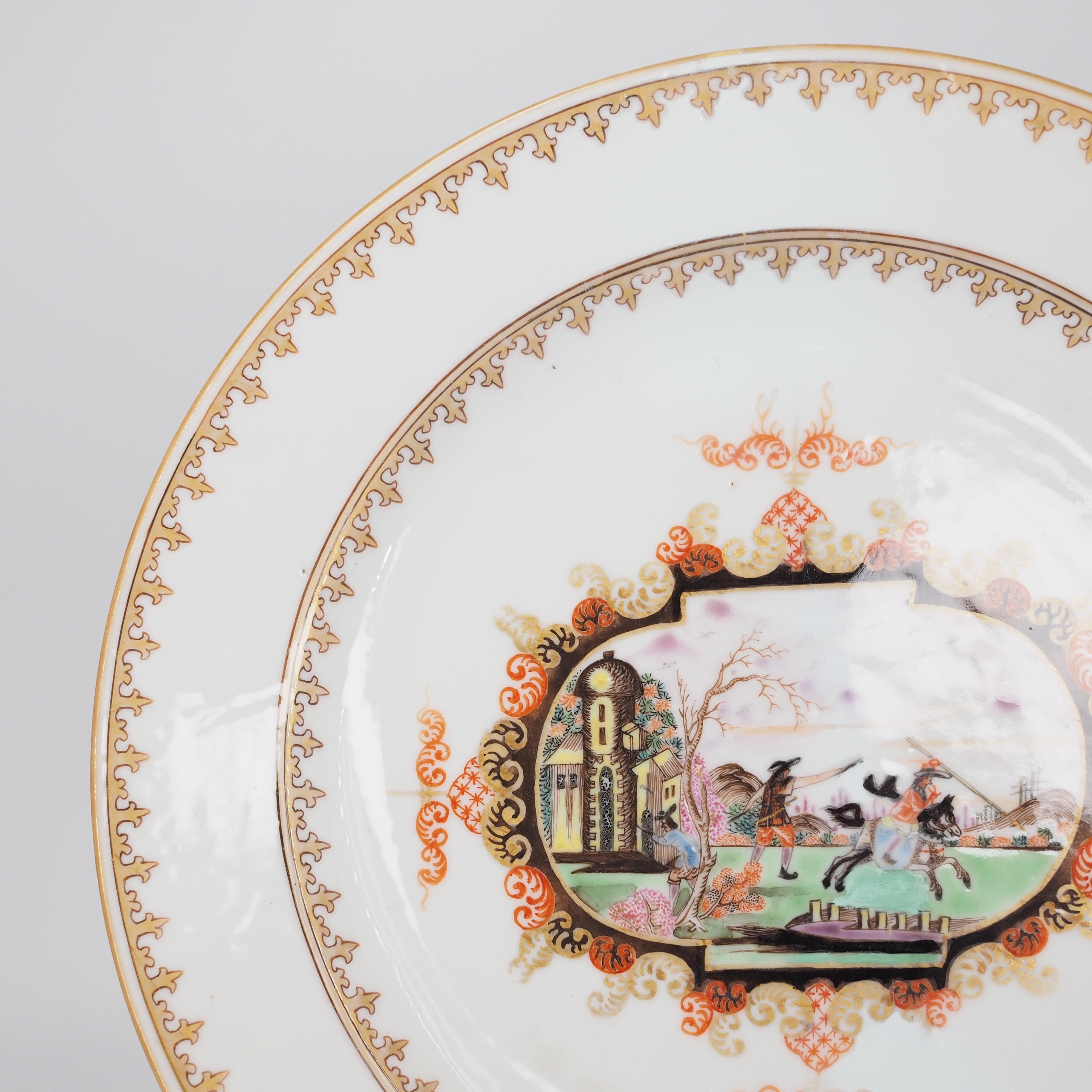 Chinese export plate with rare Meissen style cartouche containing a landscape including a soldier and horseman, within two gilt lambrequin borders. 

Unmarked, c.1730.