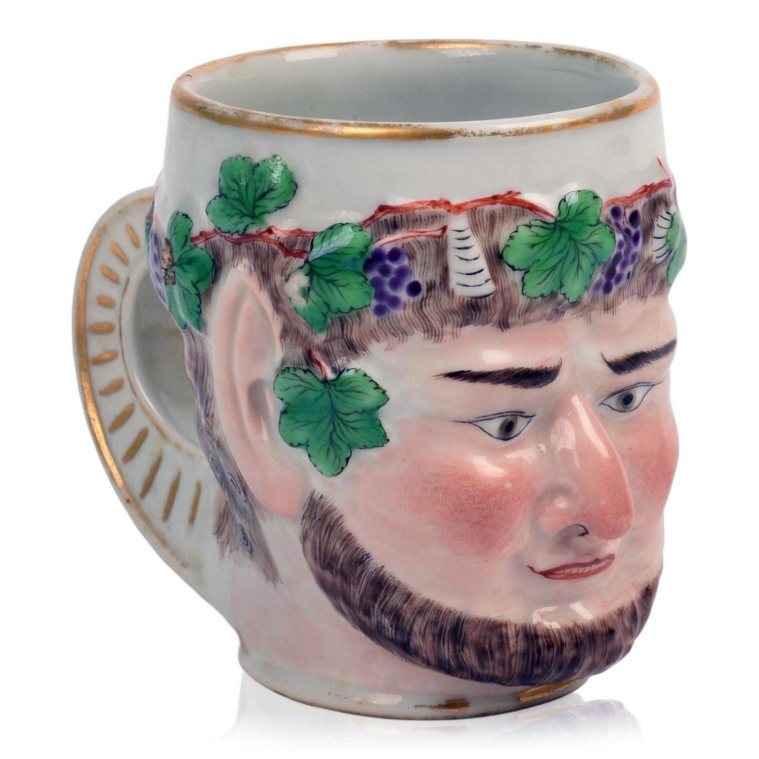 Chinese Export Porcelain Bacchus Mug After Derby Porcelain,
Circa 1785.

The Chinese Export porcelain mug is modeled after a Derby porcelain original as the head of Bacchus, the face naturalistically & delicately enameled.  The eyebrows, beard and