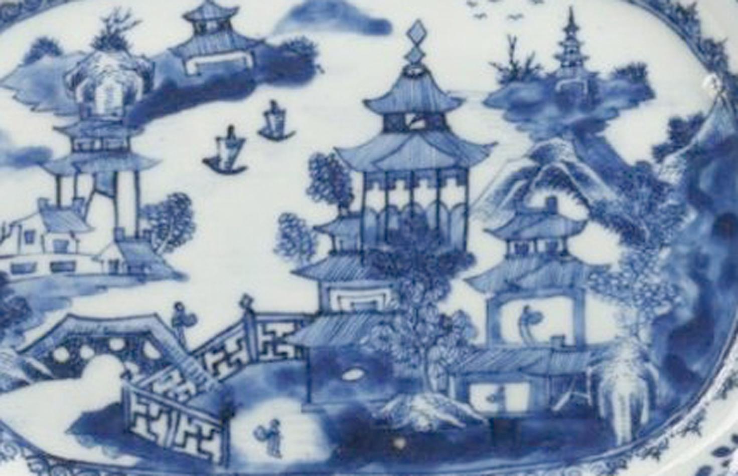 Chinese Export porcelain blue & white dish,
Circa 1770

The Chinese Export porcelain rectangular dish with canted corners is painted with a view of a pagoda and other buildings with a zig-zag fence and a figure in the garden. In the background