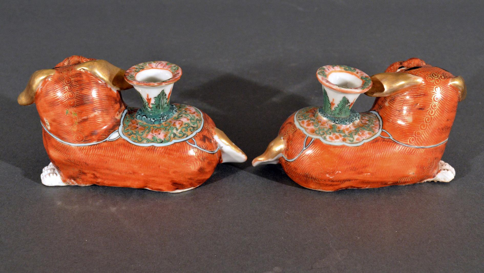 Chinese export porcelain pair of foo dog candlesticks,
Circa 1840-1860

The Chinese Export porcelain foo dog candlesticks are modeled with the dogs seated on all fours with three paws showing and facing each other. The dogs with a goofy expression