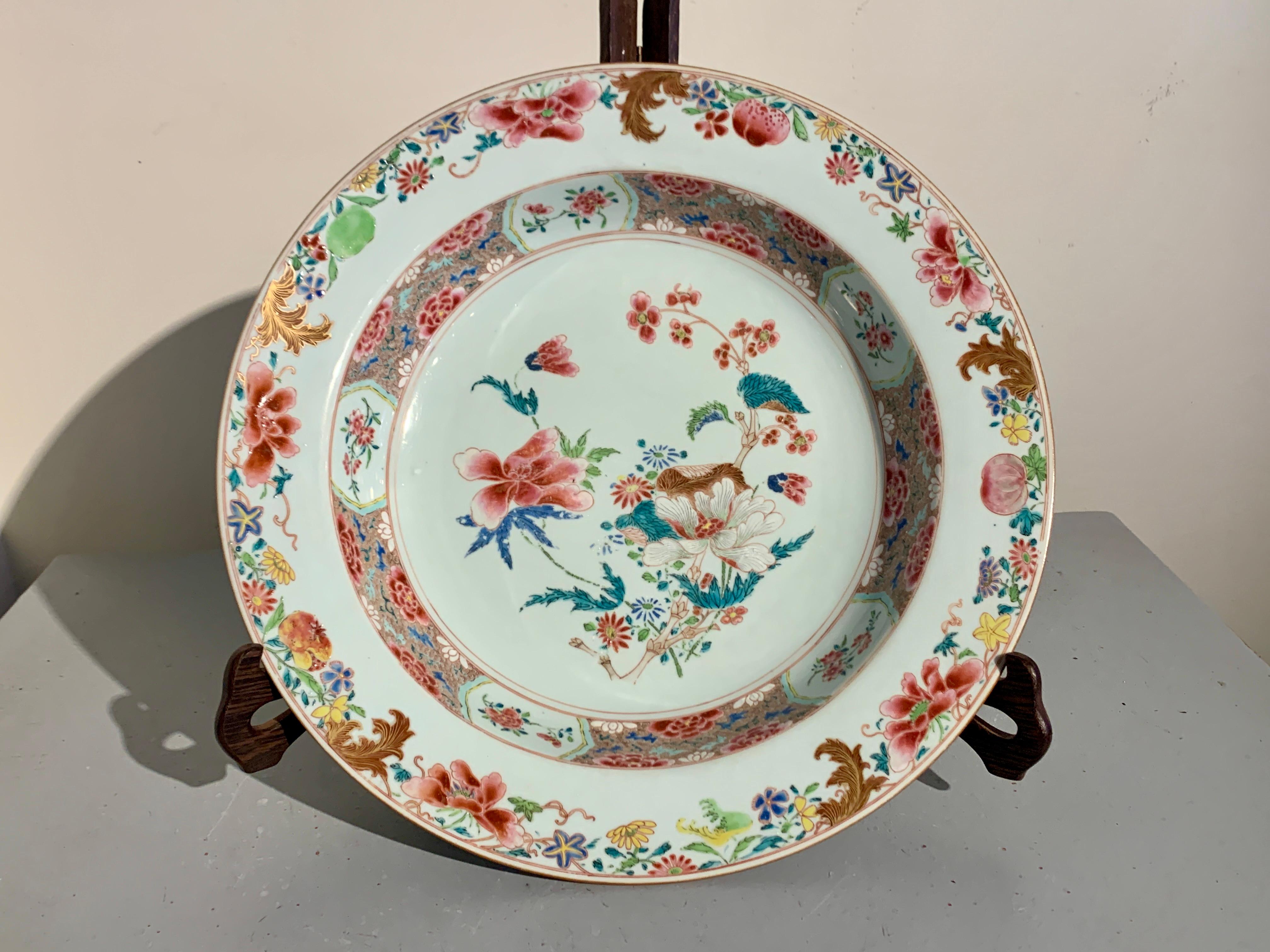 A large and impressive Chinese export famille rose enameled porcelain deep dish or shallow basin, first half of the 18th century, Qing Dynasty, Yongzheng or Qianlong Period, China.

The dish of large and gracious proportions, featuring a deep well