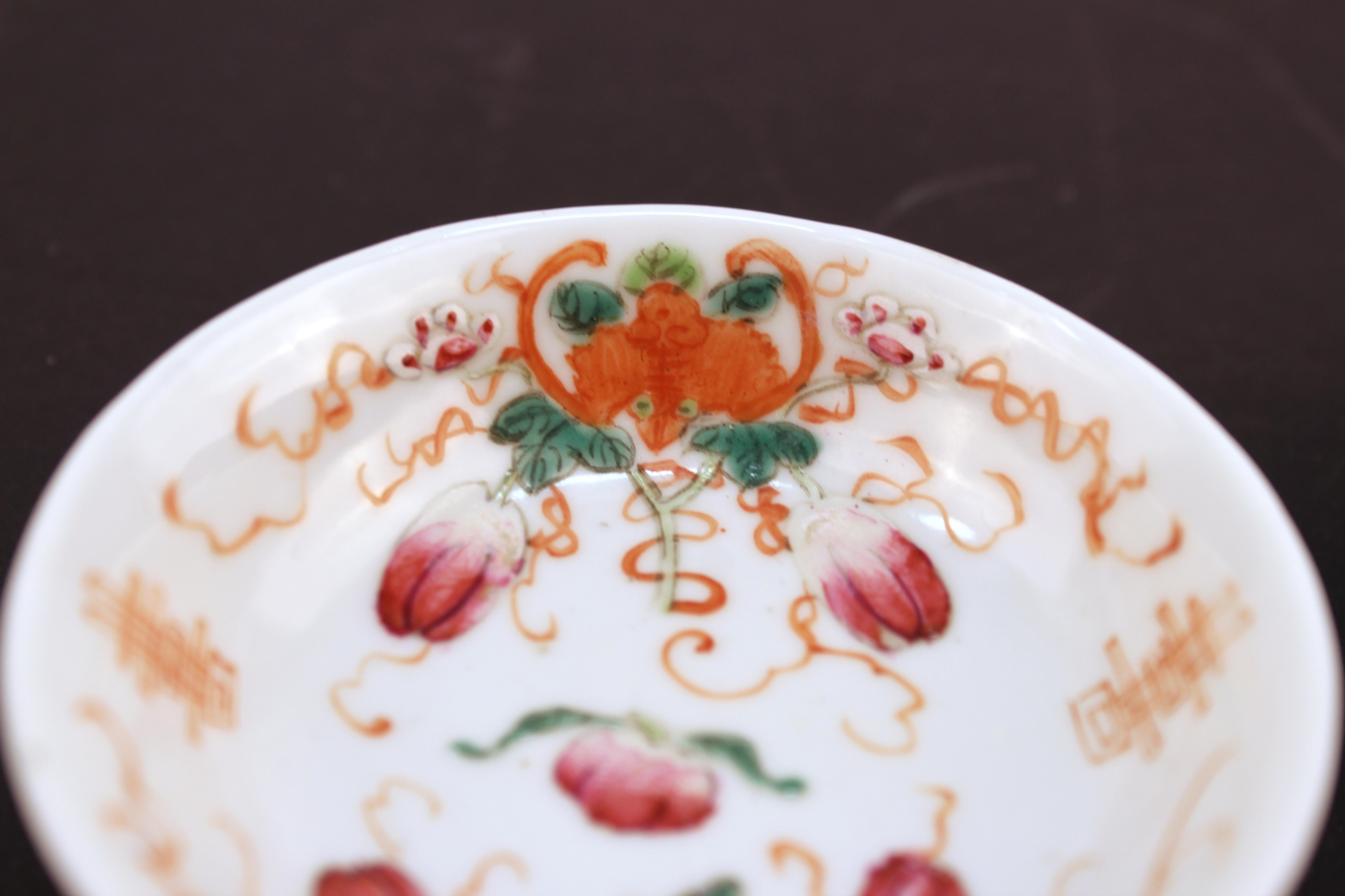 Chinese export porcelain tea plates of the famille rose, hand-painted with a theme of bats and floral motifs. Each one marked on the bottom. In great vintage condition.