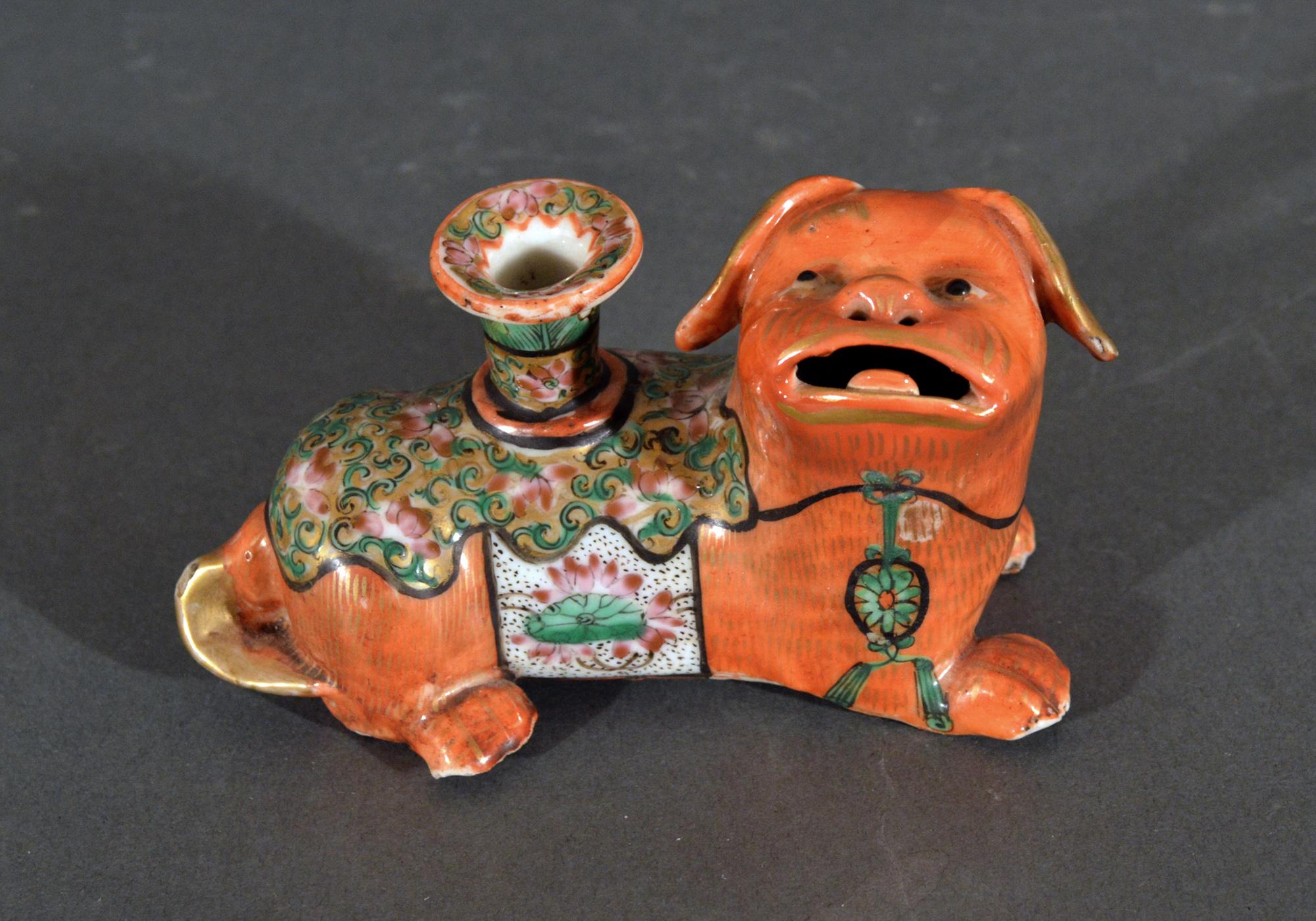 Chinese Export Porcelain foo dog candlesticks
Circa 1860

The Chinese Export porcelain foo dog candlesticks or joss sticks are modeled with the dogs seated on all fours and facing each other with their heads tipped upwards and enameled in an