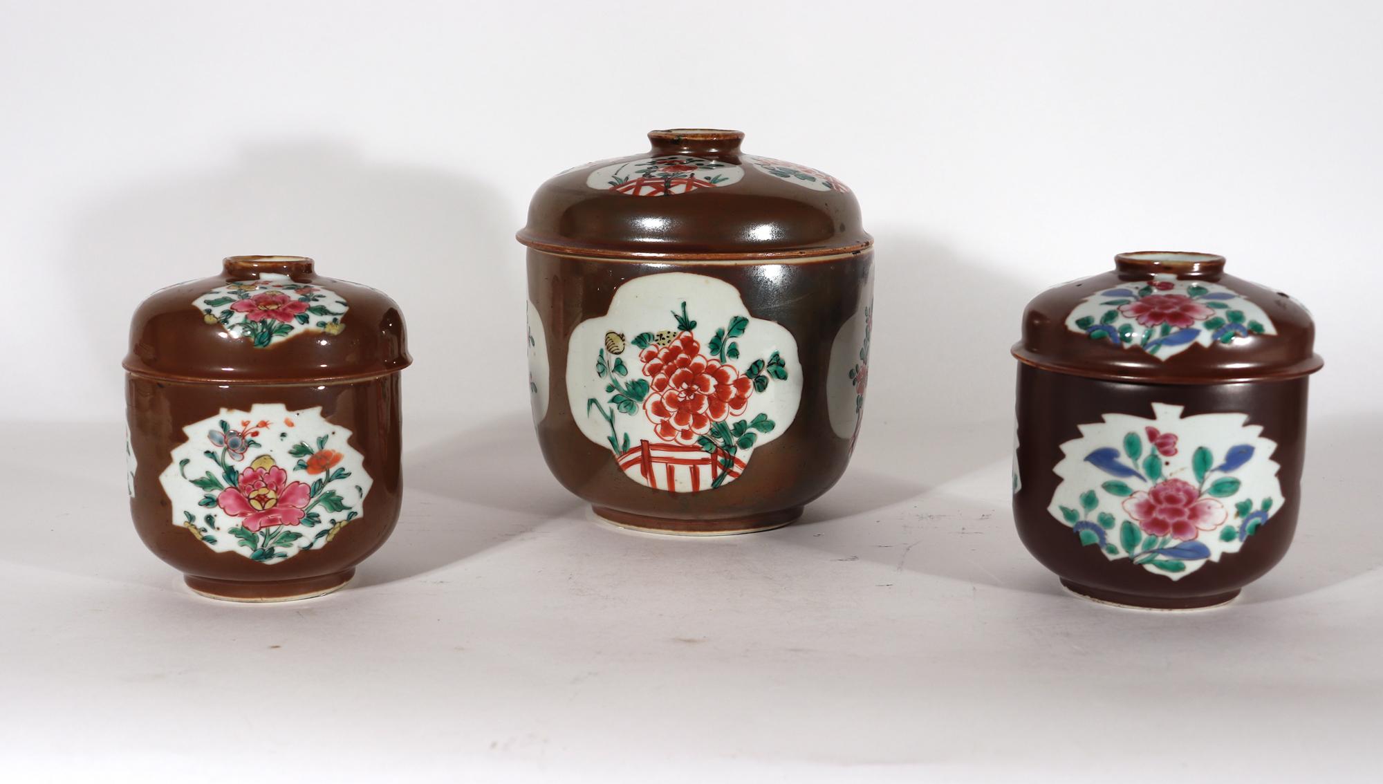 Chinese Export Porcelain Group of Five Famille rose & Batavia-ware Chocolate-colored Urns & Covers
1750s

The  Chinese Export porcelain circular jards and covers are painted with a chocolate Batavia-ware ground with leaf-shaped panels of famille