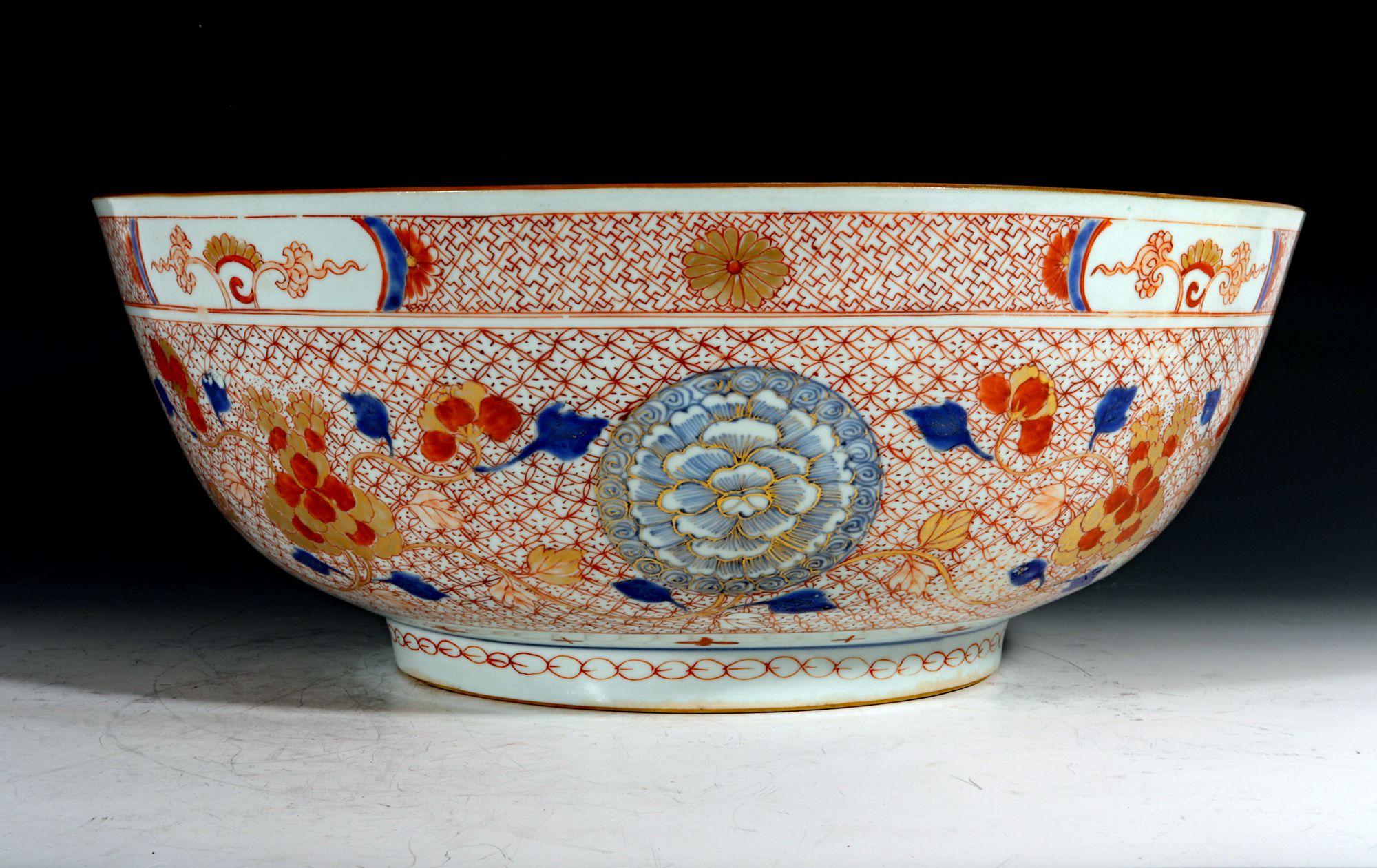 Chinese Export Porcelain Rouge de Fer Large Punch Bowl,
Imari,
circa 1735-50

The Chinese Export porcelain large Imari punch bowl is painted on the exterior with underglaze blue and gold chrysanthemums and iron-red and gilt scrolling branches