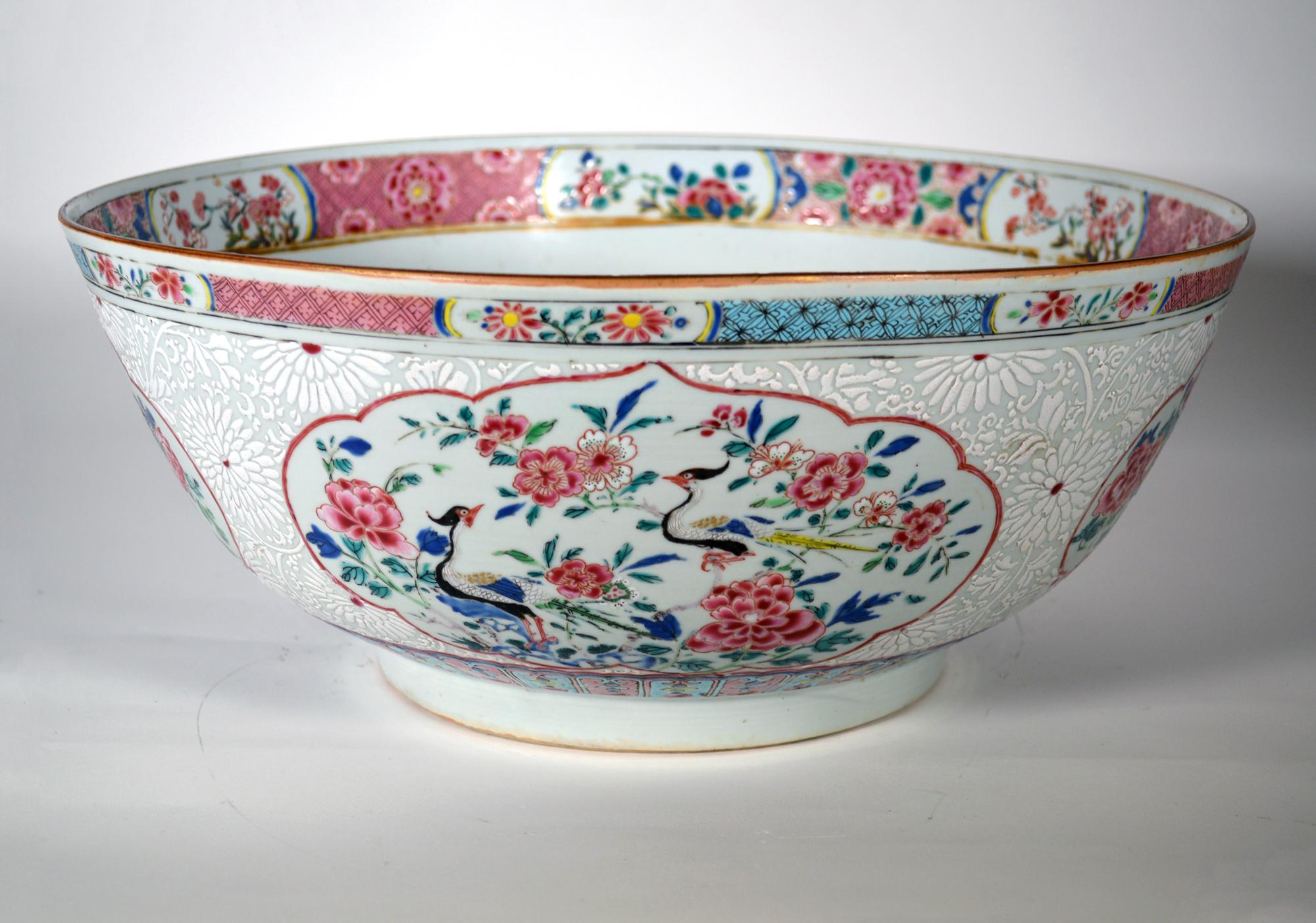 Chinese Export porcelain large Famille Rose punch bowl,
Circa 1765

A superb large Chinese Export famille rose porcelain punch bowl with a Bianca-supra-Bianca ground forming large flower-heads with shaped alternating panels containing exotic