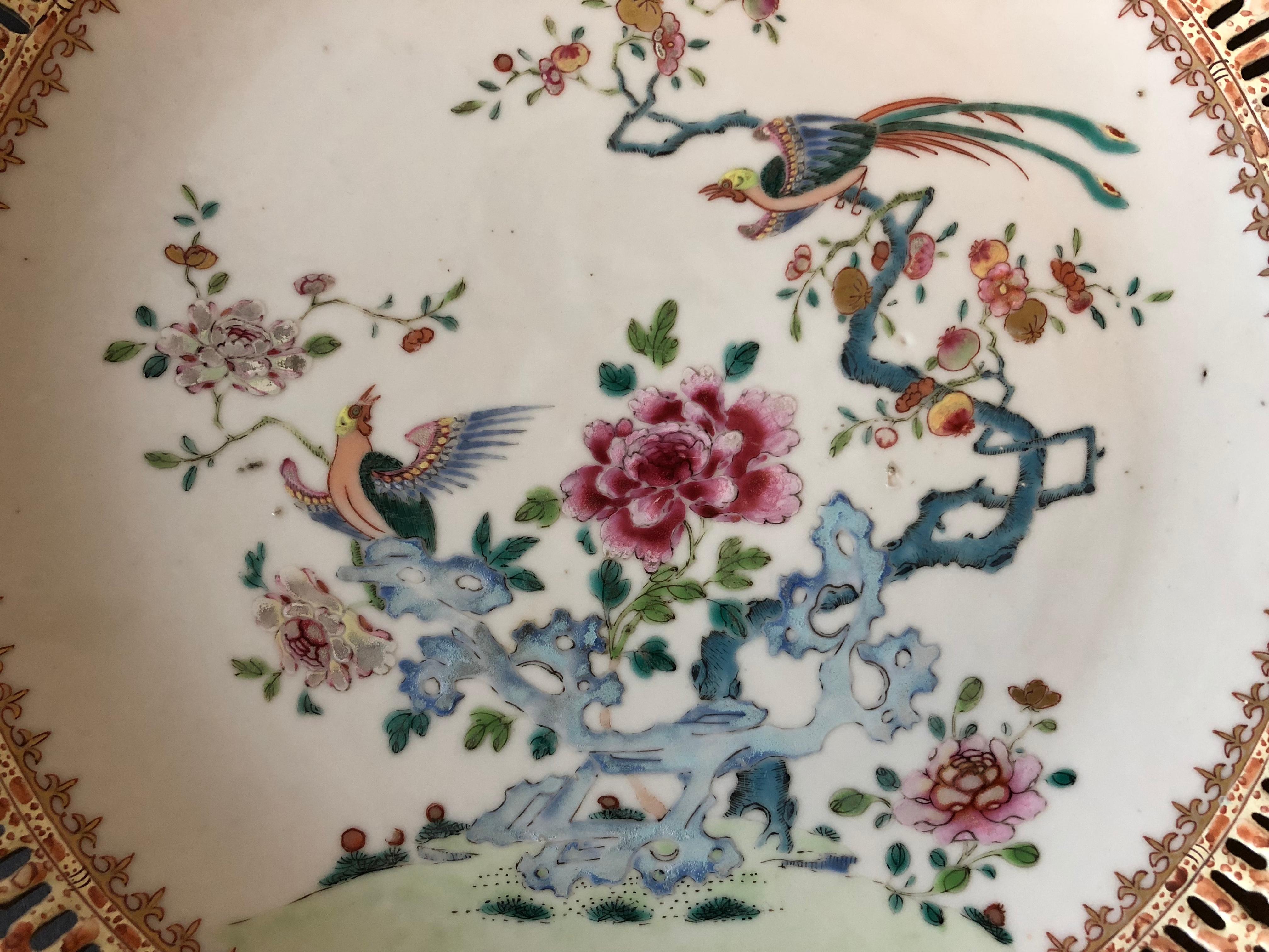 The Qianlong dish with famille rose enamels and gold paint, the central decoration composed of finely painted peonies and phoenixes resting on a tree, with openwork rim.
