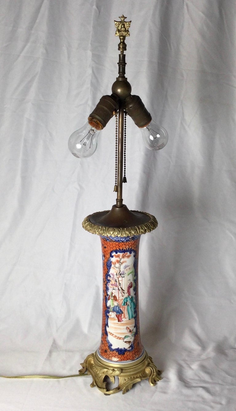 Hand painted Chinese porcelain beaker vase with gilt bronze mounts now as a lamp. The 19th century vase with finely cast bronze top and base, lamped in the 1920s to make an exceptional lamp. Shade is for photographic purposes and not included with