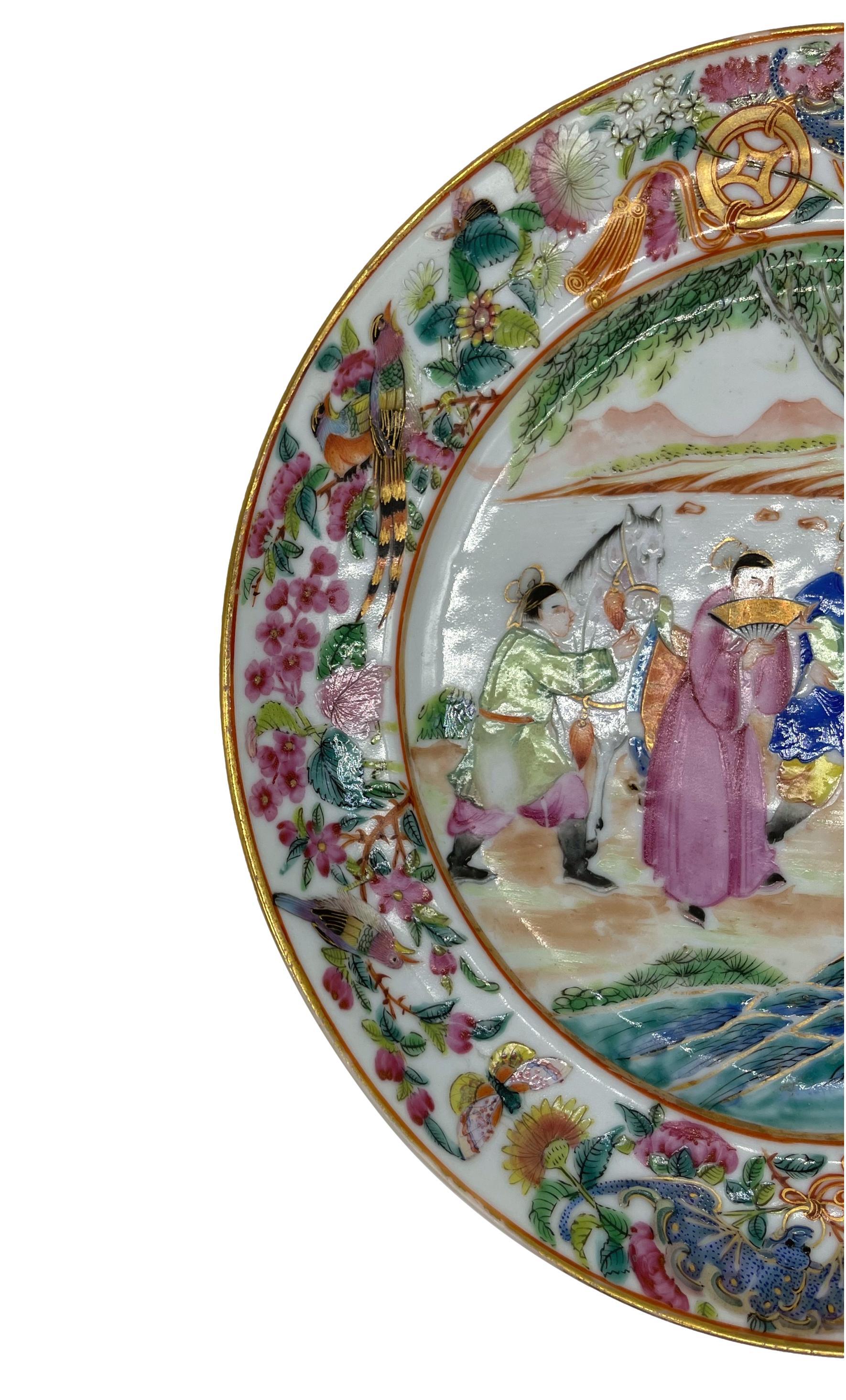 Chinese Export Porcelain Rose Mandarin plate, ca. 1840, with a central design depicting a pavilion court scene with five figures, with hyper-vivid enamels and fine gilt accents, with multi-layered raised enamels, with blue Taihu stones to the