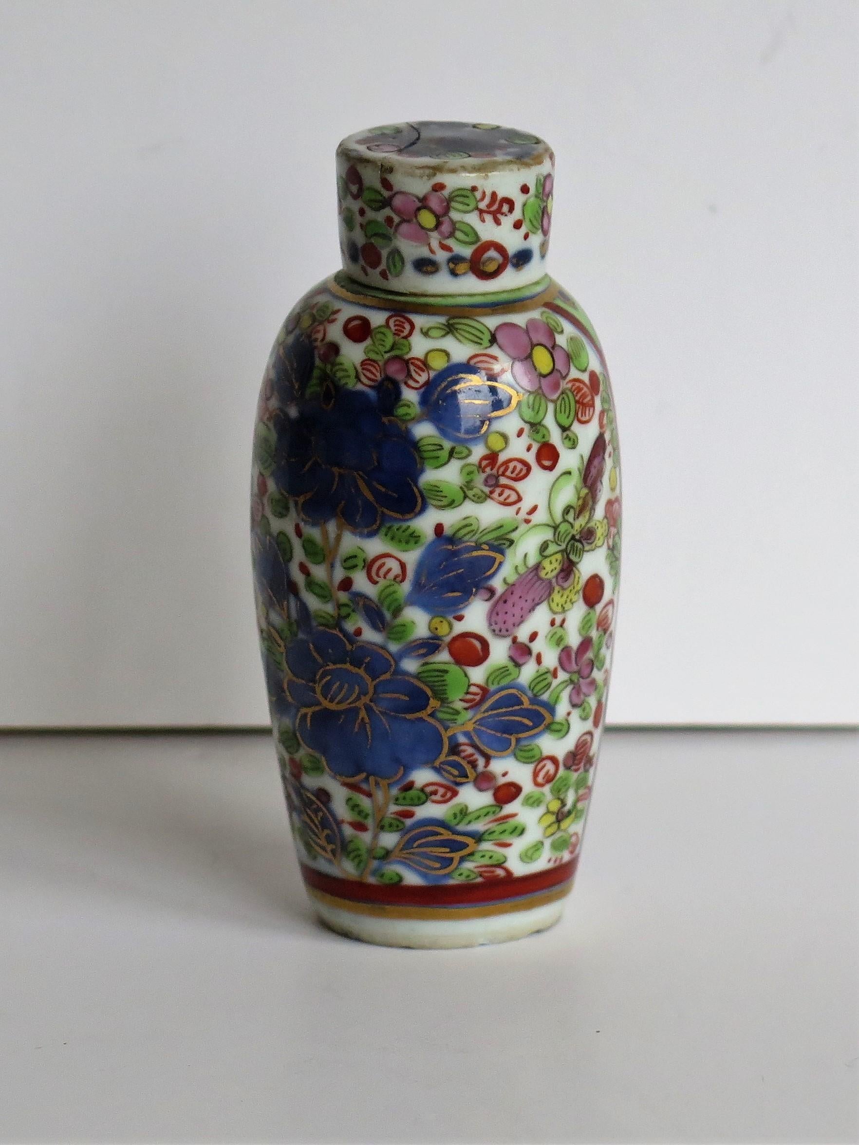 This is a Chinese porcelain Snuff Bottle or small Lidded Bottle, finely hand painted with flowers, leaves and butterflies and dating to the early 19th century of the Qing Dynasty.

The bottle has a good baluster shape and a small cylindrical loosely