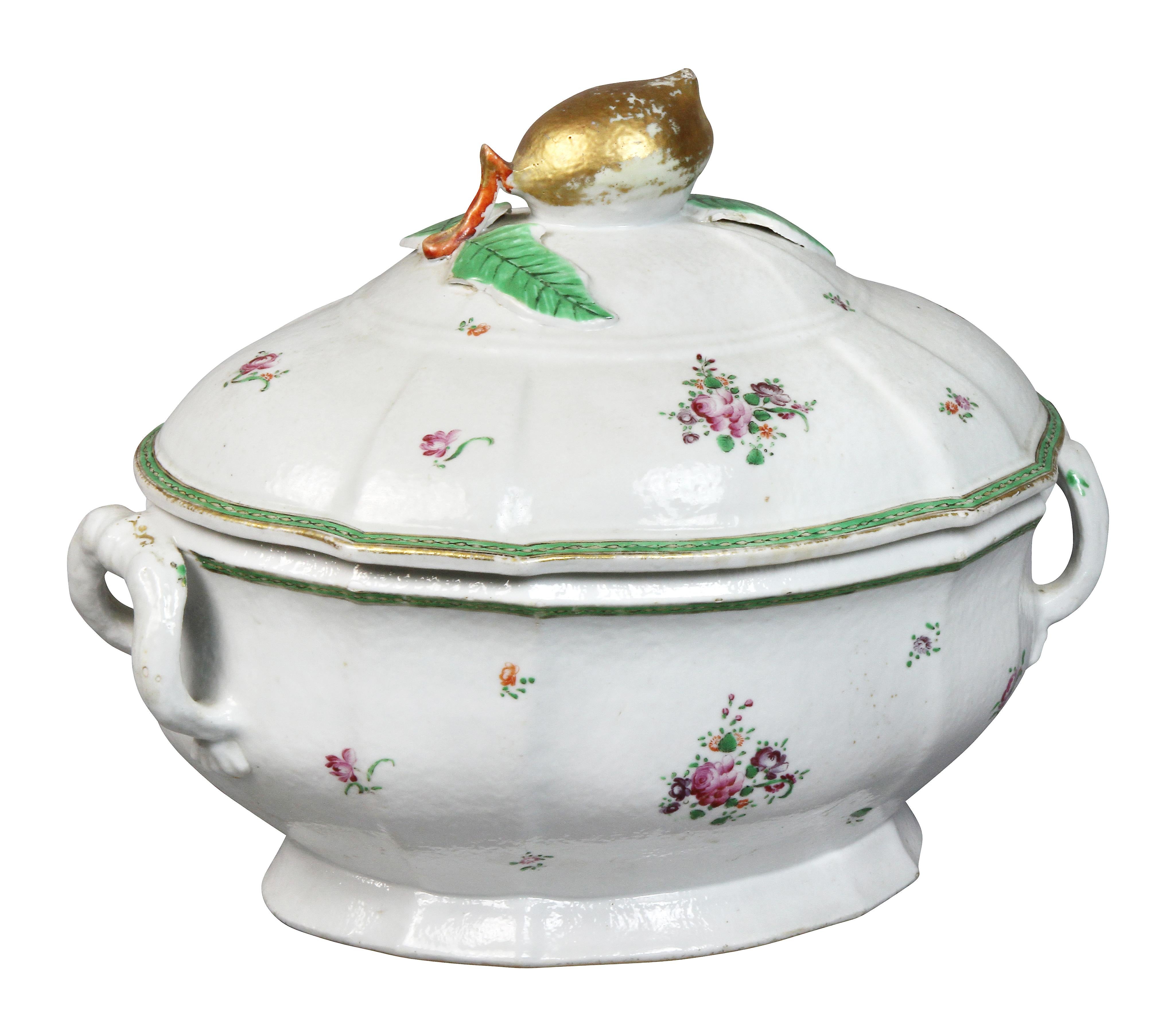 With domed cover with gilt lemon finial on a conforming base with two handles.