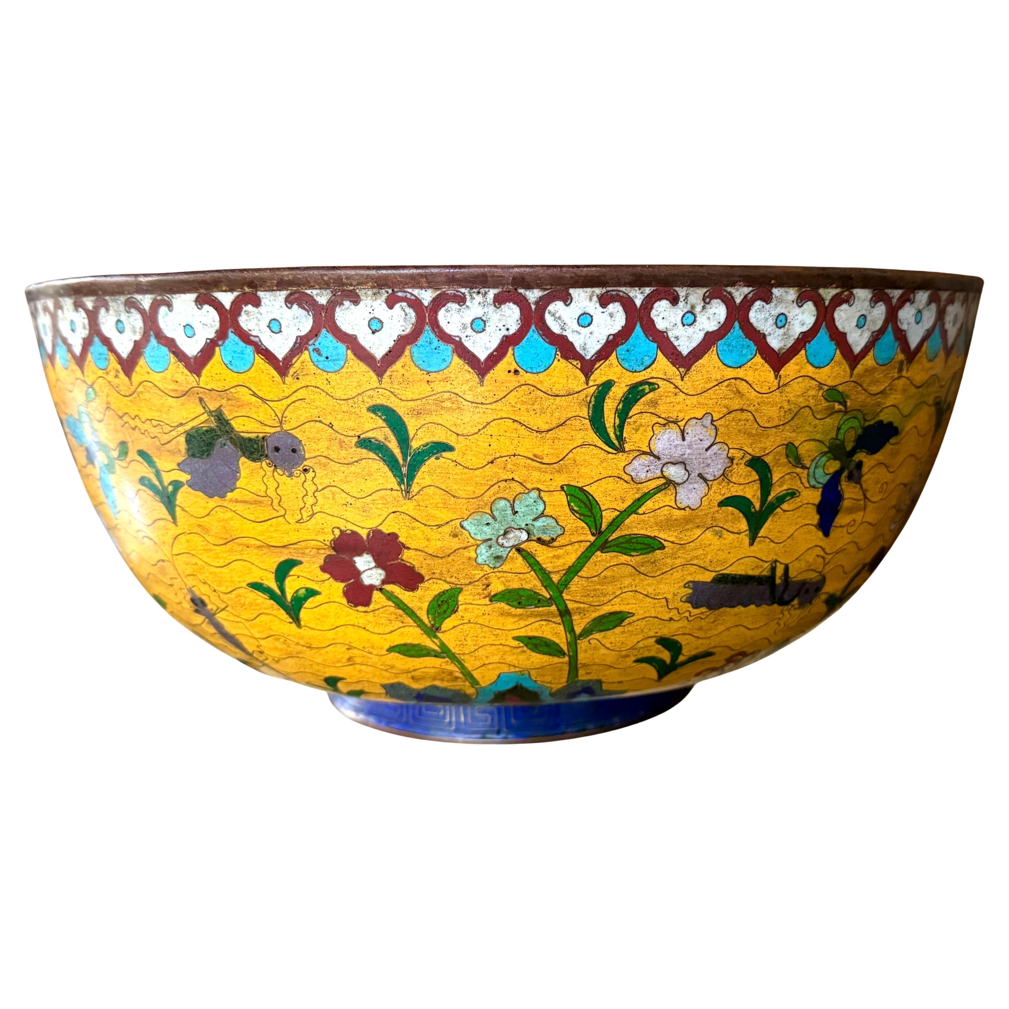 Gran cuenco de esmalte Cloissone de la dinastía Qing, de exportación china, marcado con el sello metálico del emperador Qianlong  (1735-1795) en la parte inferior. Esta obra grande y magnífica presenta un dibujo de colores raros y vibrantes y está