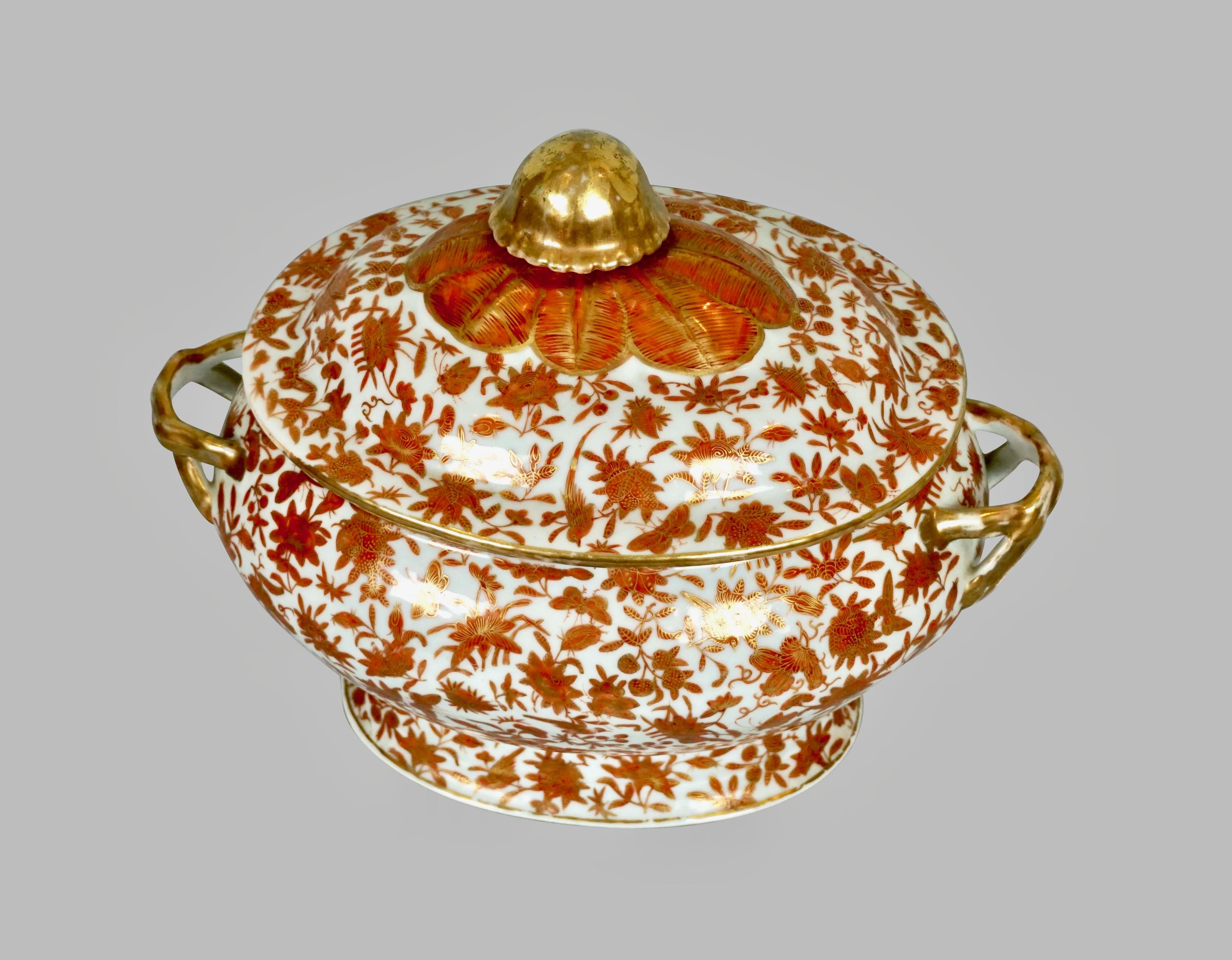 This Chinese export sacred bird and butterfly pattern soup tureen is decorated overall in a traditional palette of orange and gold. The pattern first appeared around 1800 and incorporates long established Chinese motifs of birds, butterflies and