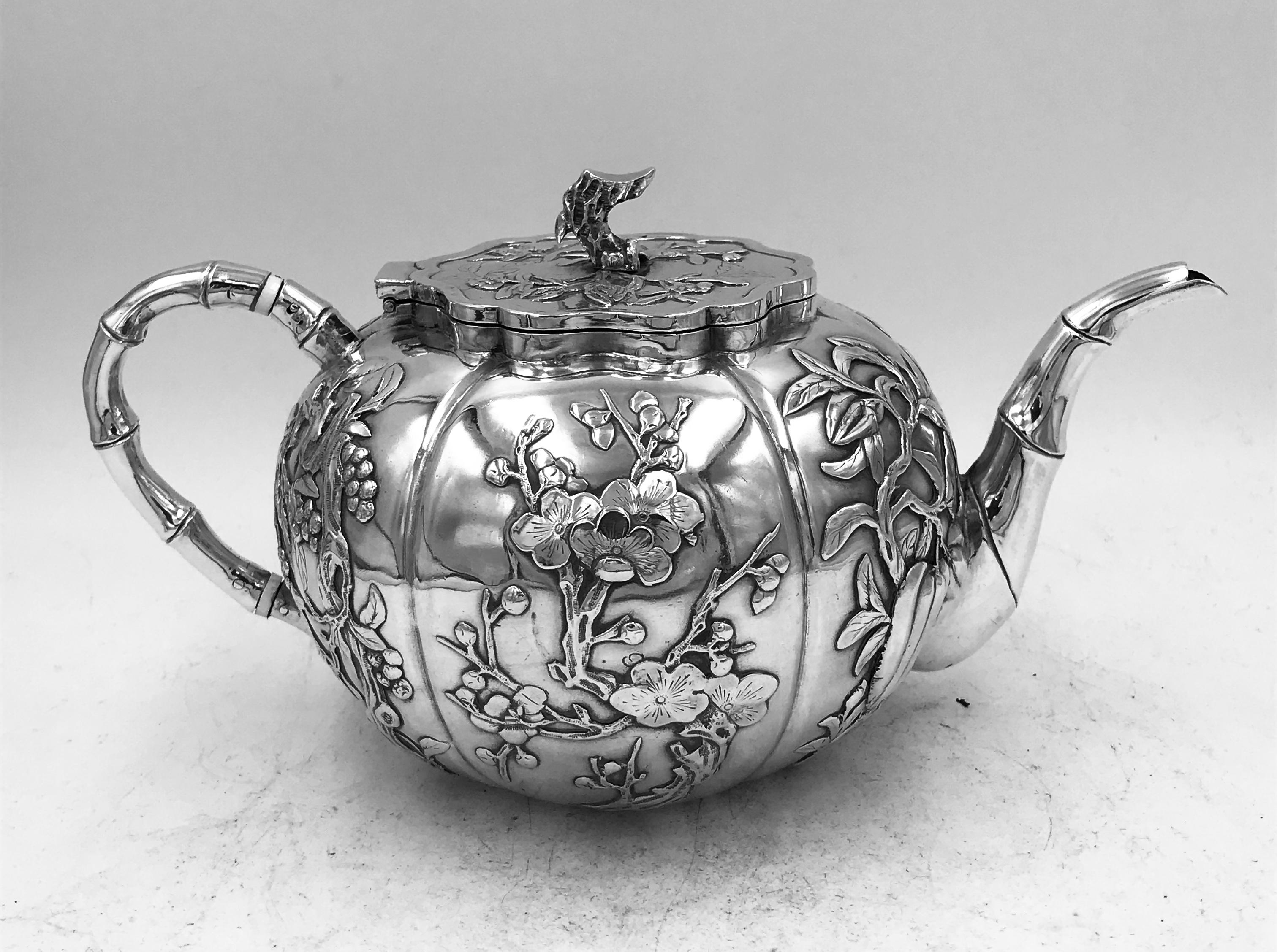 A Chinese Export Silver 3-piece Teaset of round segmented form, profusely decorated with flowers and foliage. The retailer's mark on all three pieces is TS, which can be either Tien Shing  天盛, or Tai Sang  大生. The maker's mark is 伯 (Bo) on the sugar