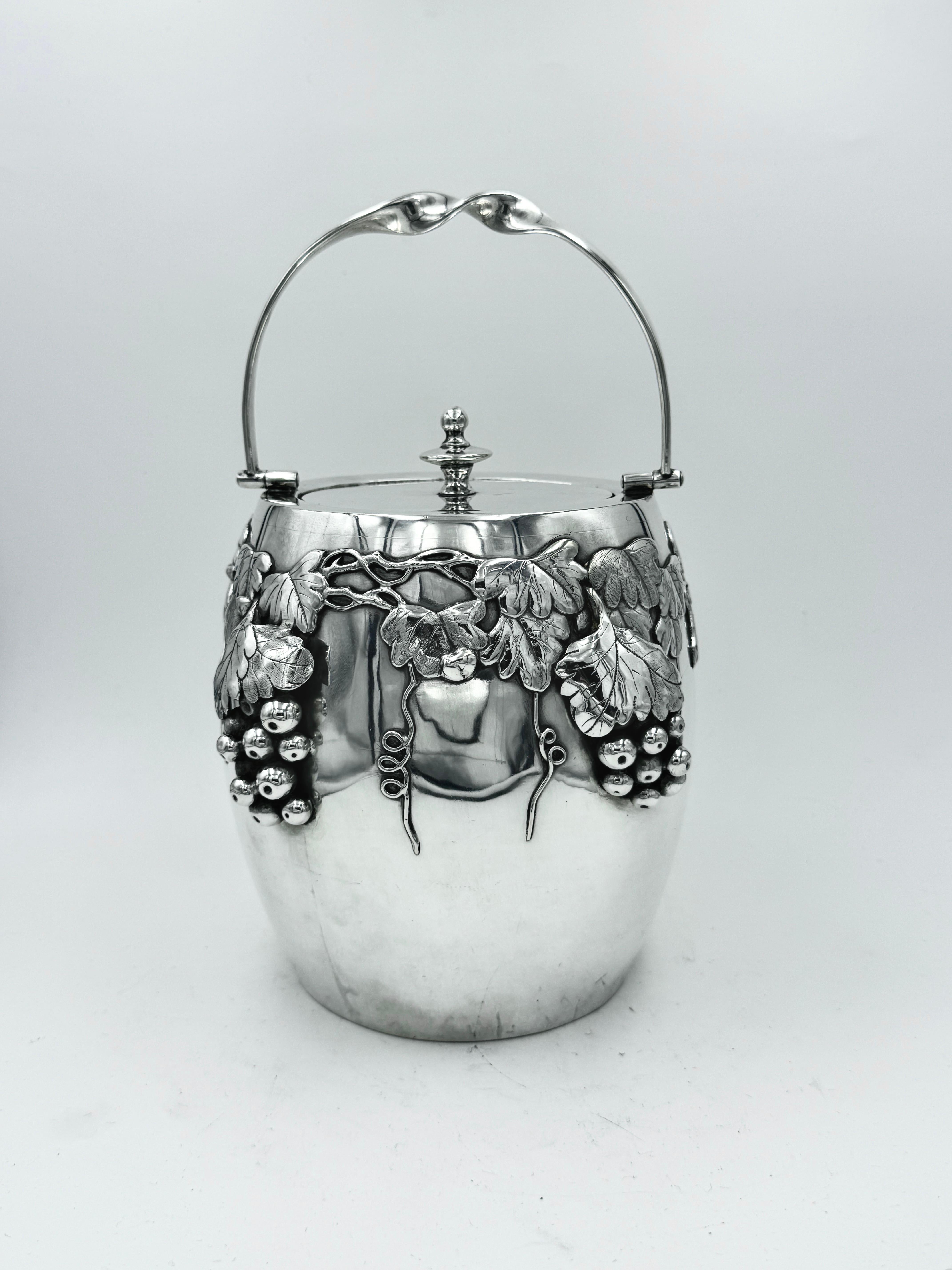 Chinese Export Silver Biscuit Box circa 1890, of barrel shape with plain pull-off lid. This extremely unusual box, which could equally be used for ice as well as biscuits (but not at the same time!) is decorated with well defined grapes and trailing