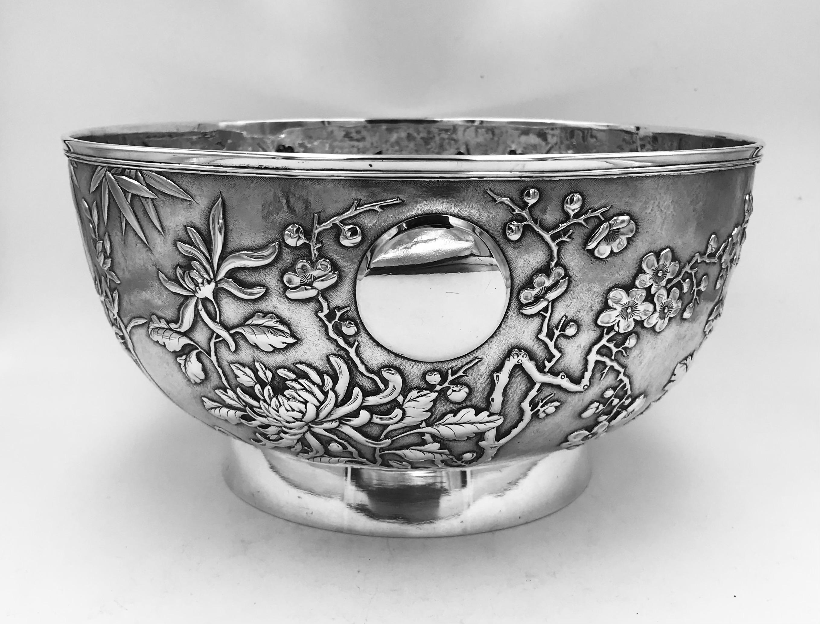 Chinese Export Silver Bowl, profusely decorated with chrysanthemum, prunus, iris, and bamboo, and with a vacant circular cartouche. The bowl dates from circa 1895 and is in very good, crisp condition. It was made by Shao '绍记’ (ShaoJi), and retailed