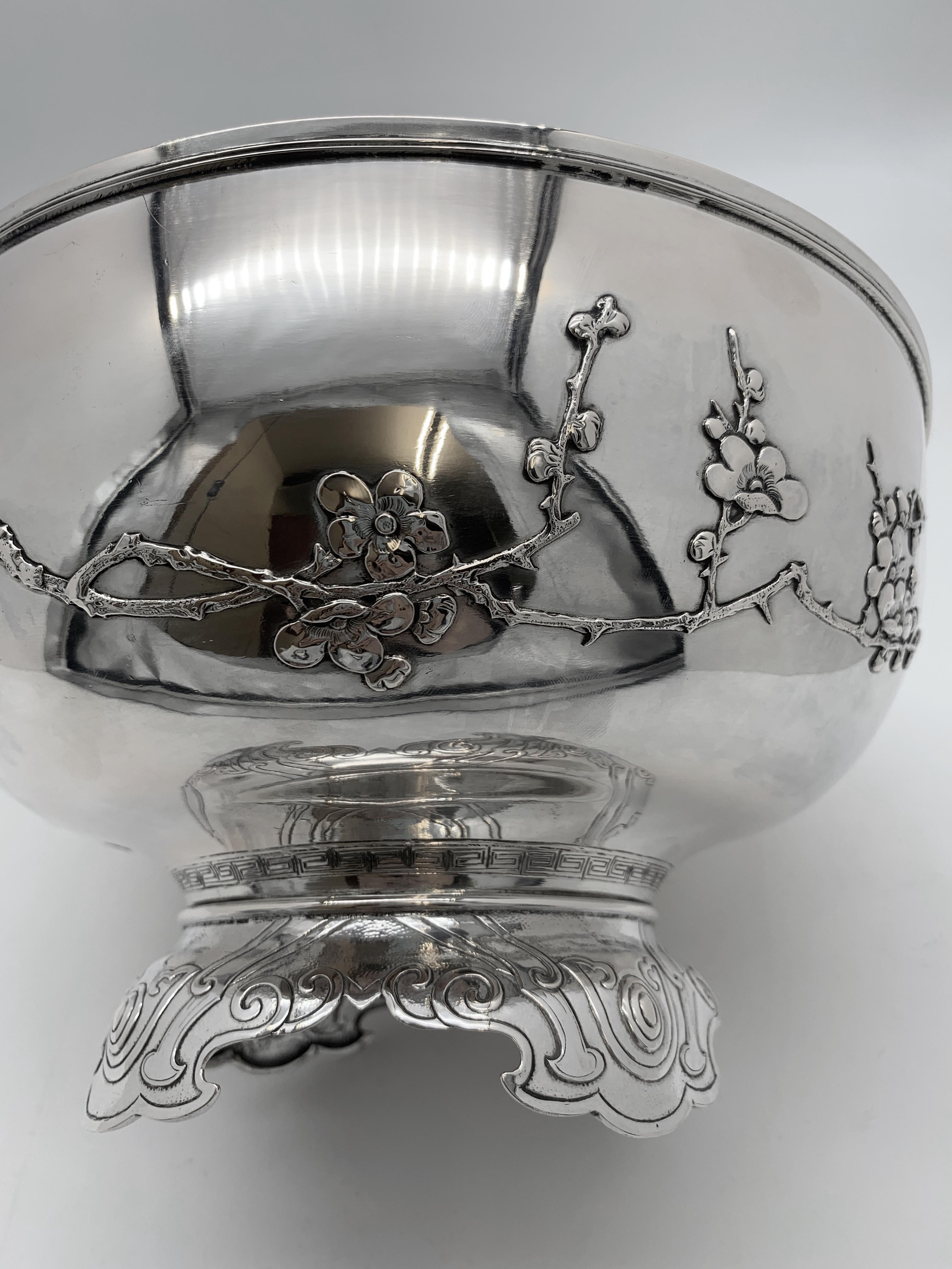 Chinese Export Silver Bowl, of round form with applied prunus around two-thirds of the bowl leaving the remainder plain, in keeping with Chinese tradition seen on paintings where blank space is left. The foot has a very unusual ruyi pattern embossed