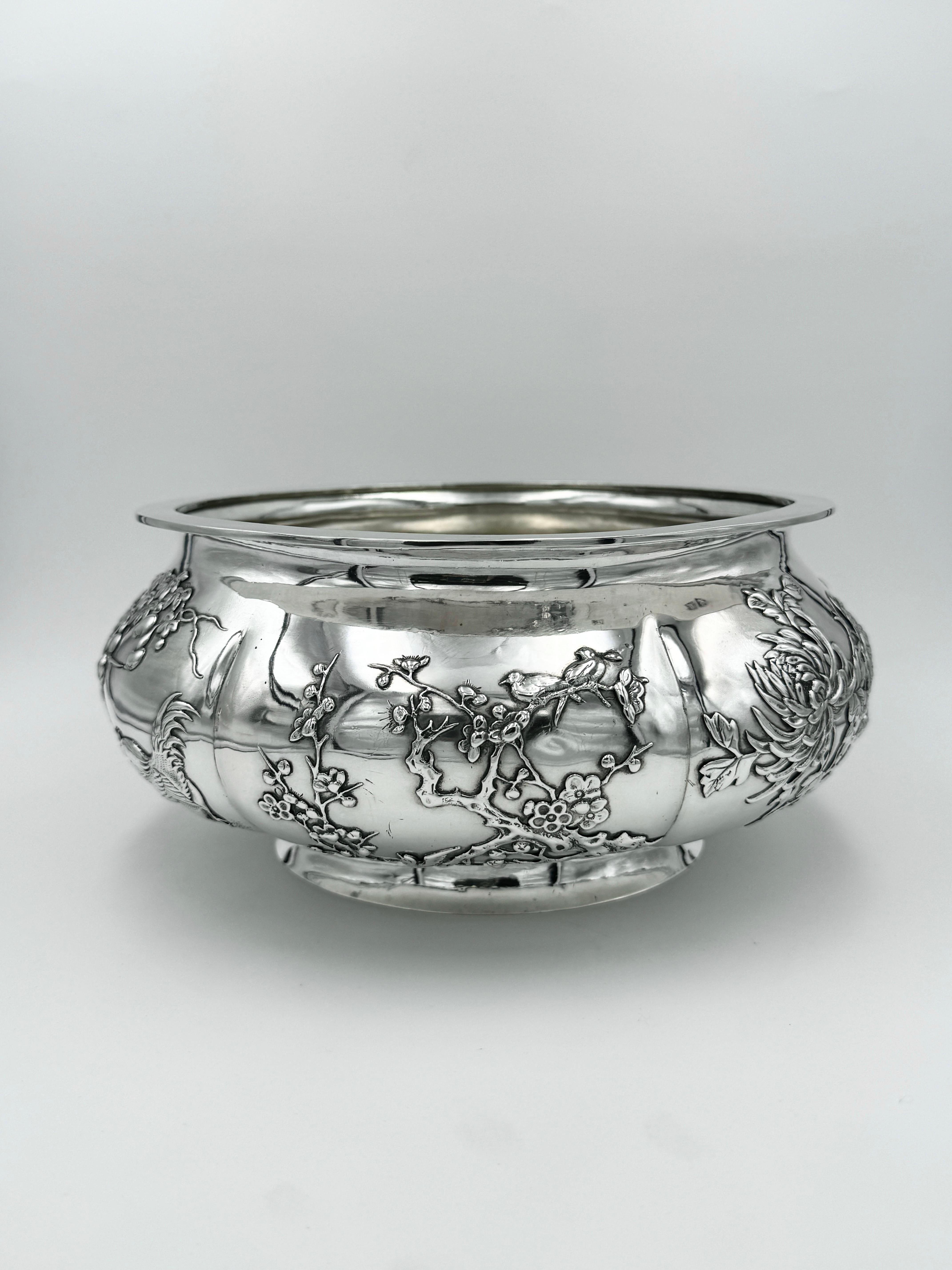 Chinese Export Silver Bowl, of hexafoil form with applied decoration depicting various plants and birds, showing chrysanthemum and peacock, chrysanthemum only, magpie and plum blossom, gourd and rooster, iris and egret, and bamboo and birds. The
