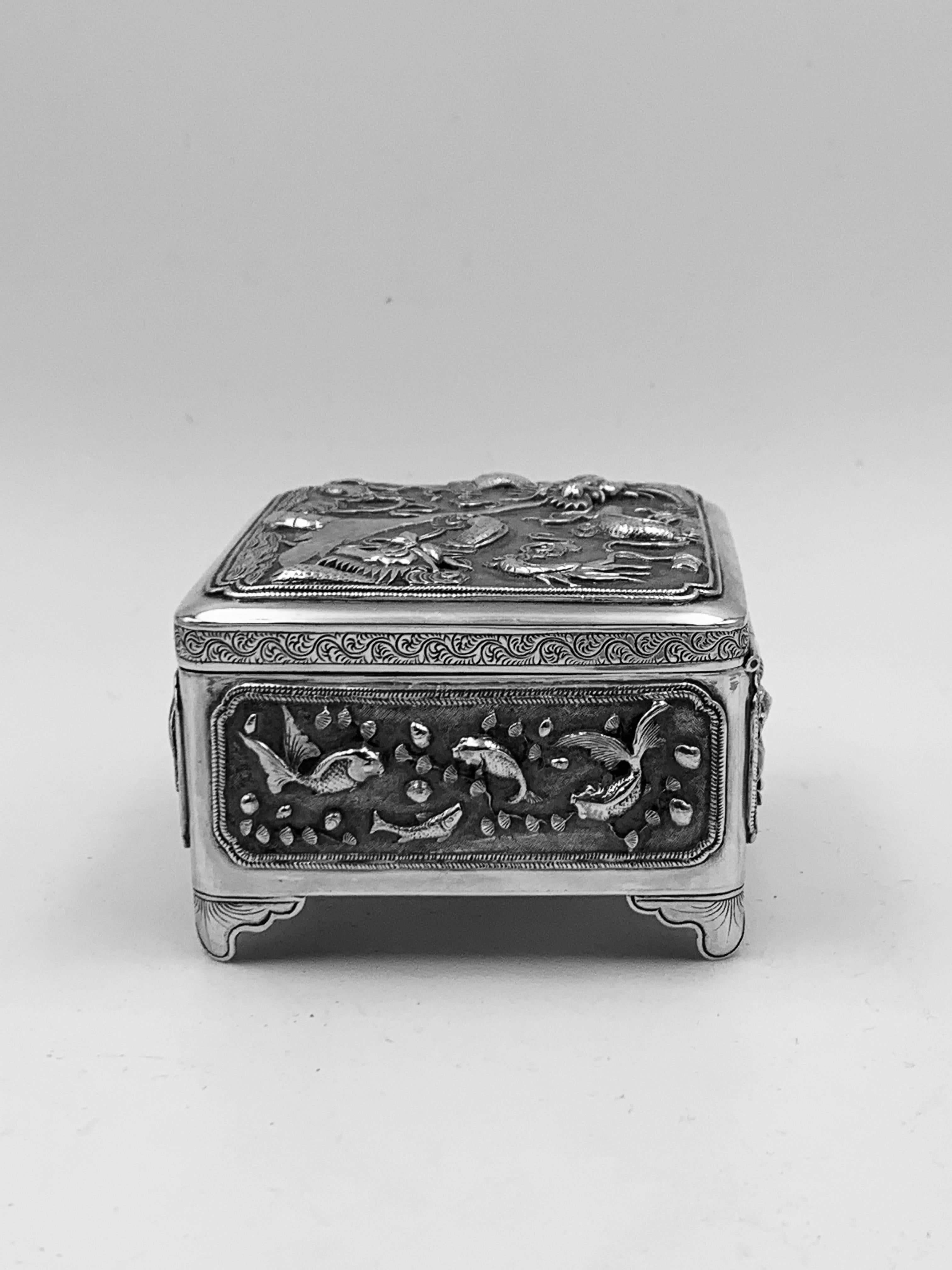 A Chinese Export Silver Box, c1890. Two dragon on the hinged lid. Embossed and chased with fish and crustaceans. Marked with LH, for 'Luen Hing' ’联兴‘, a retailer based in Shanghai, between 1890 and 1909, and a maker's mark '昆興' (Kun Xing). There are