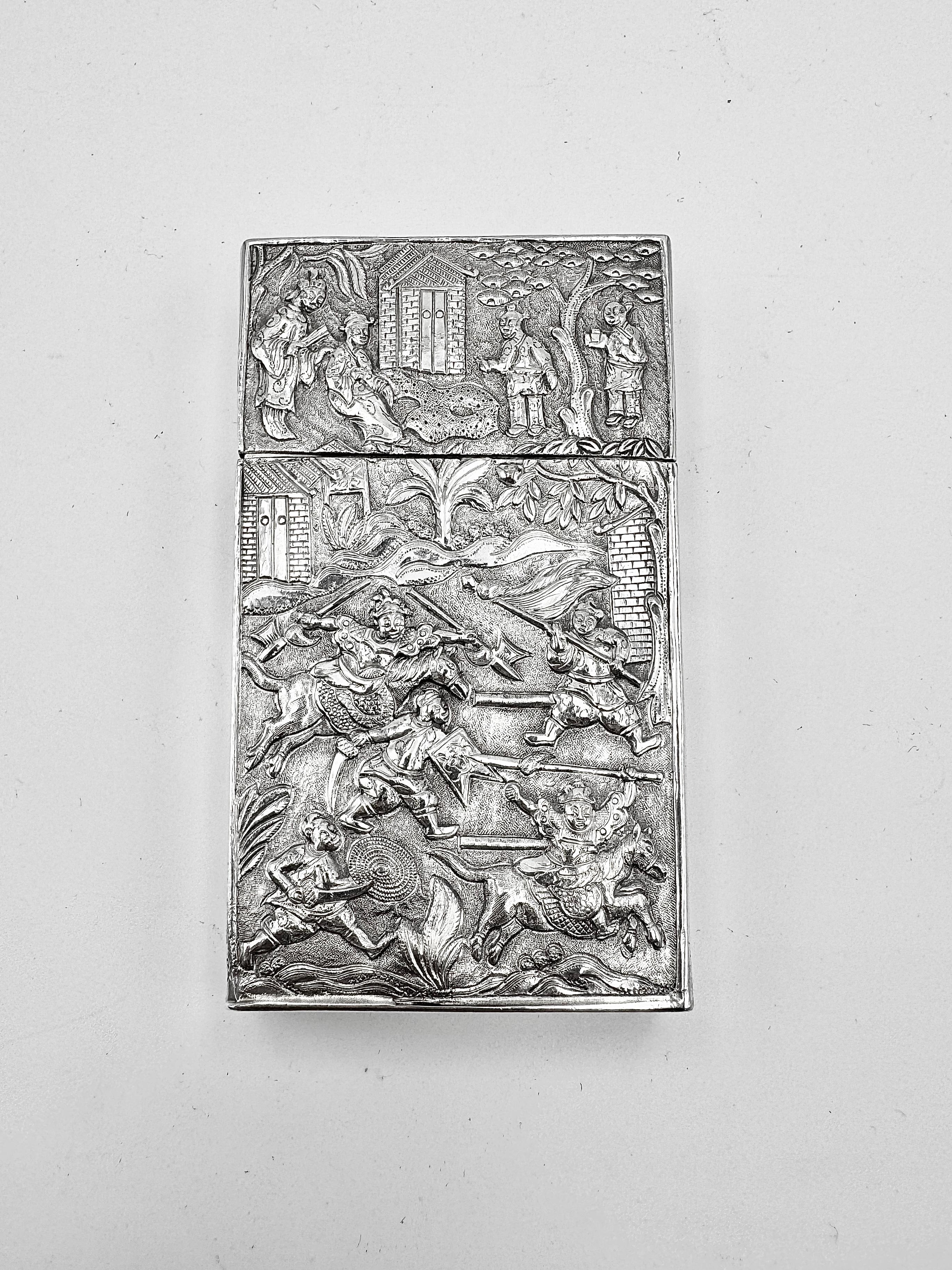 Chinese Export Silver Card Case, circa 1835, embossed and chased with a scene of figures in battle, while the other side depicts scenes of farming, horse riding, and studying. The edges of the card case are decorated with grapes and vines. There is