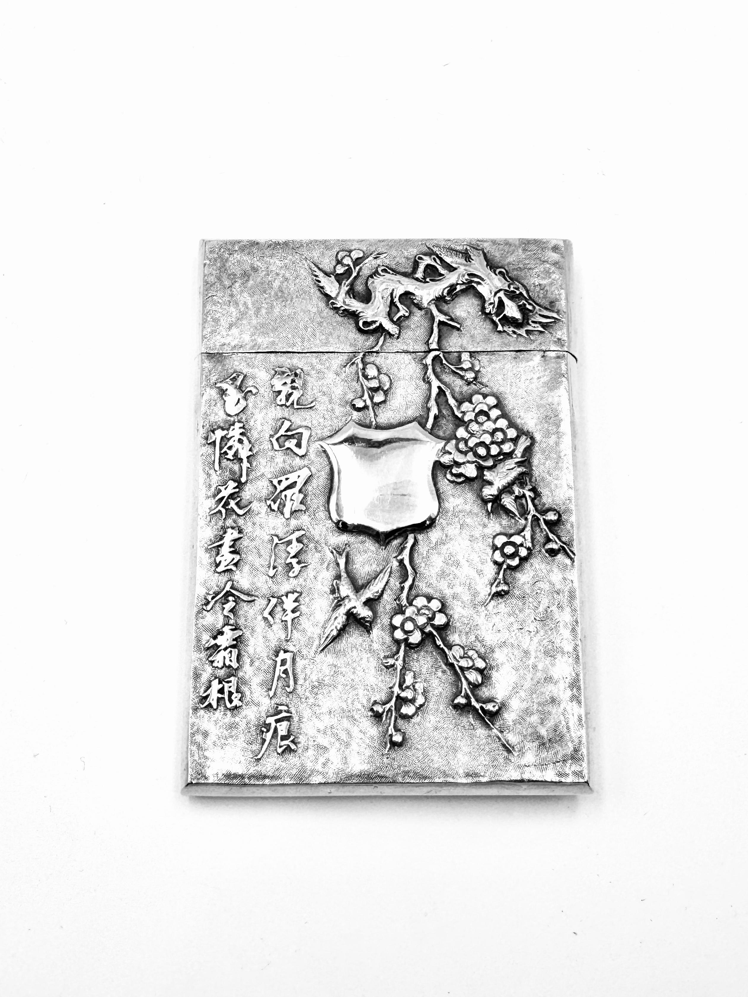 Chinese Export Silver Case embossed and chased with a dragon playing with a fireball on one side, and decorated on the other side with a poem — “亲向罗浮伴月痕，至怜花尽冷霜根” (Qin Xiang Luo Fu Ban Yue Hen, Zhi Lian Hua Jin Leng Shuang Gen) — accompanied by two