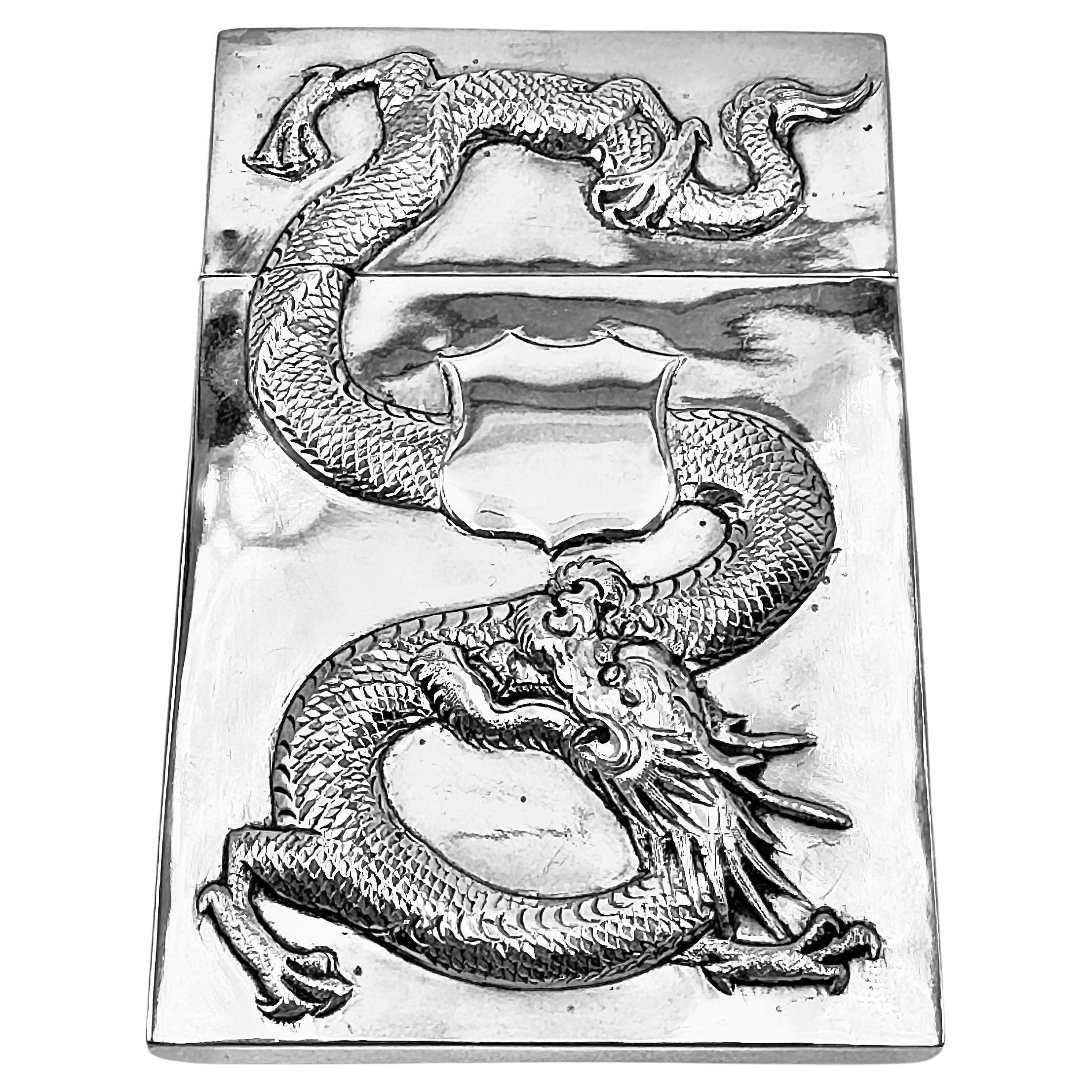 Chinese Export Silver Card Case, circa 1900, embossed and chased with a dragon on both sides and a vacant shield-shaped cartouche. Retailed by Kwong Man Shing, and made by Zhuo (卓).

95g 

