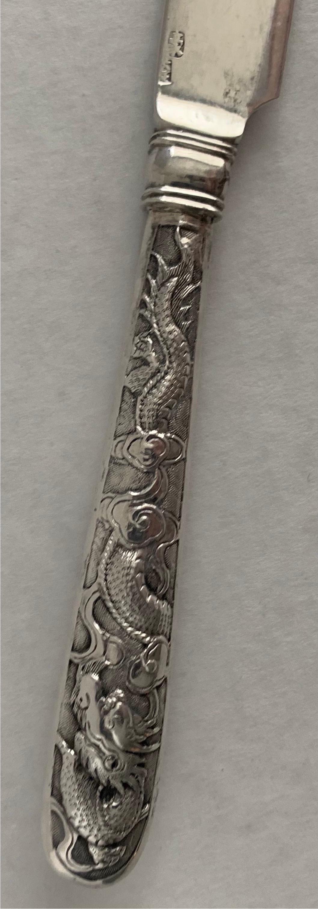 Chinese Export silver dinner knife. Overall motif on the handle of dragons with clouds. Single knife could also be used as a letter opener. Stamped markings on the blade.