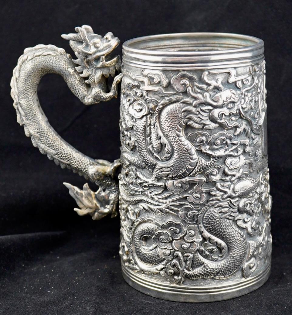 Chinese Export silver tankard with detailed repousse dragons and dragon handle. 
The tankard is 5 3/4