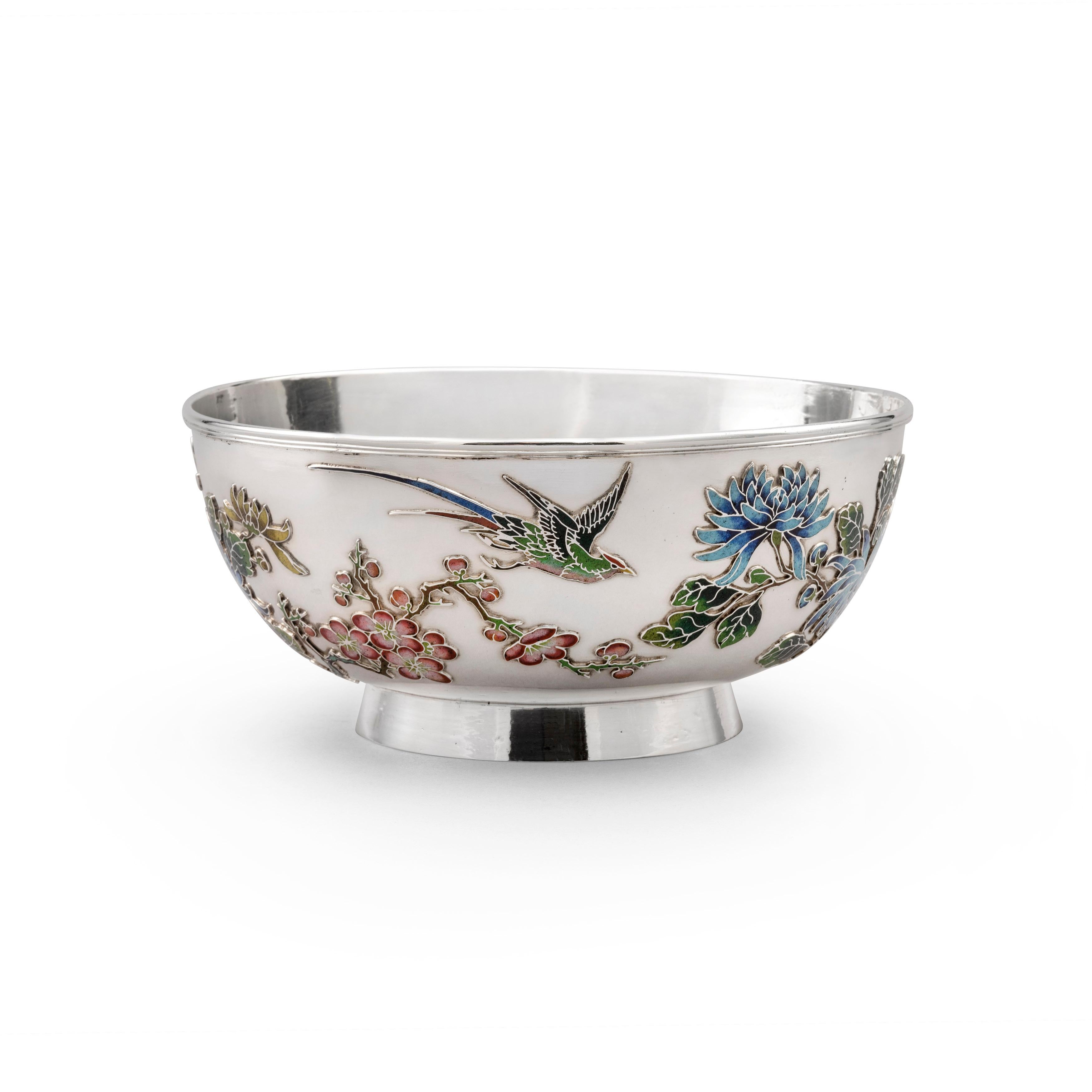 A rare and exquisite Chinese Export silver & enamel bowl, made in Shanghai around 1895 by Huang Qui Ji, and retailed by the firm of Woshing.
The bowl features two birds flying above chrysanthemum and prunus, all applied with enamel of various