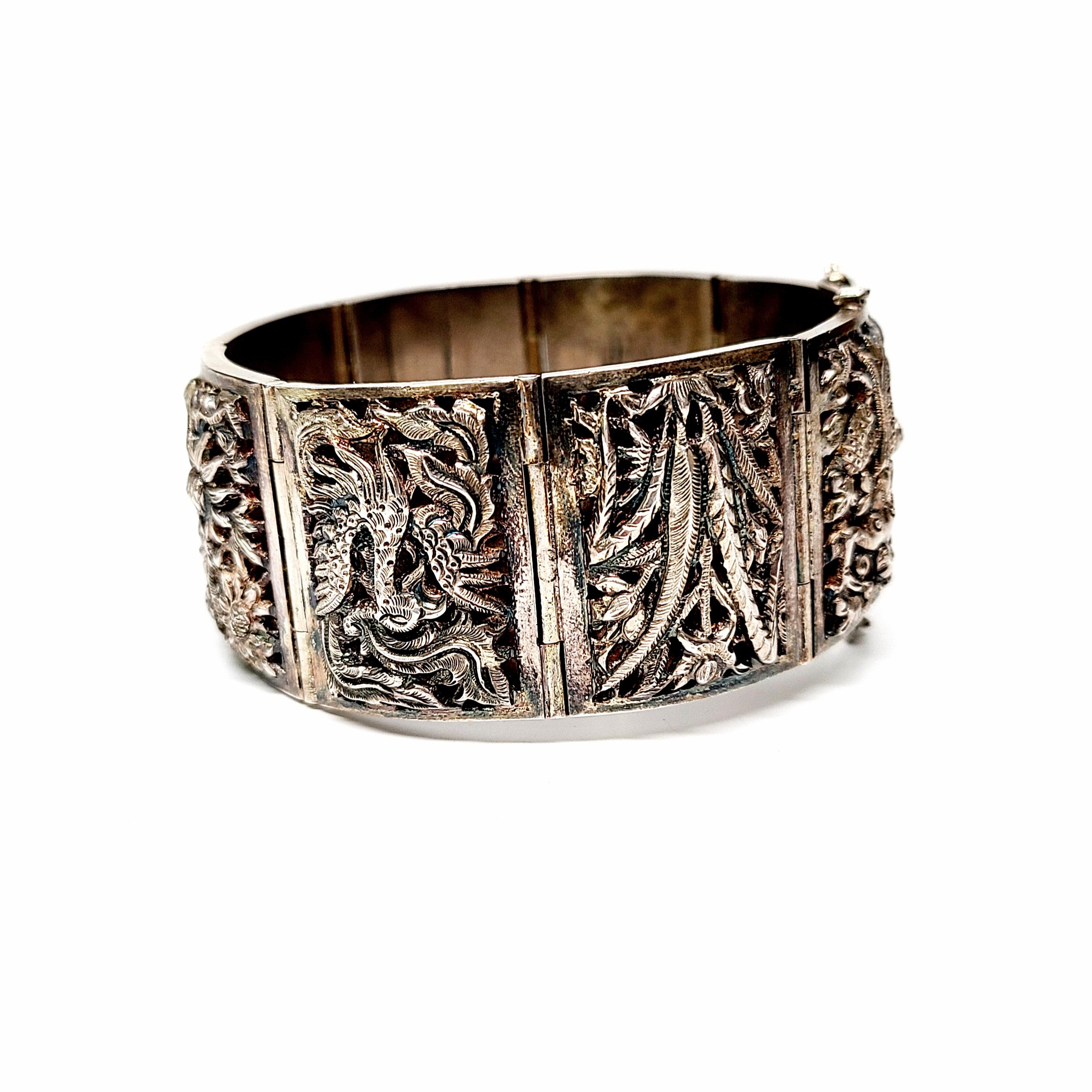 Vintage Chinese Export silver Four Seasons panel bracelet.

Bracelet features eight panel links, raised in a high relief dome-shape over a polished back of the link. In Chinese culture, four flowers represent the four seasons: orchid for spring,