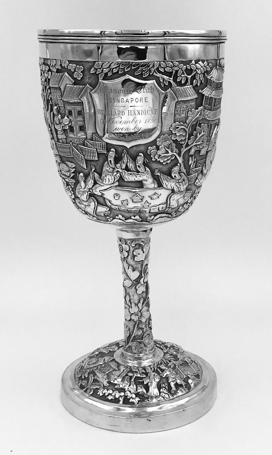 A Chinese Export Silver Goblet with figural scenes depicting scholars playing board games and other Court activities. There is an engraved inscription showing it to be used as a trophy in Singapore in 1890.