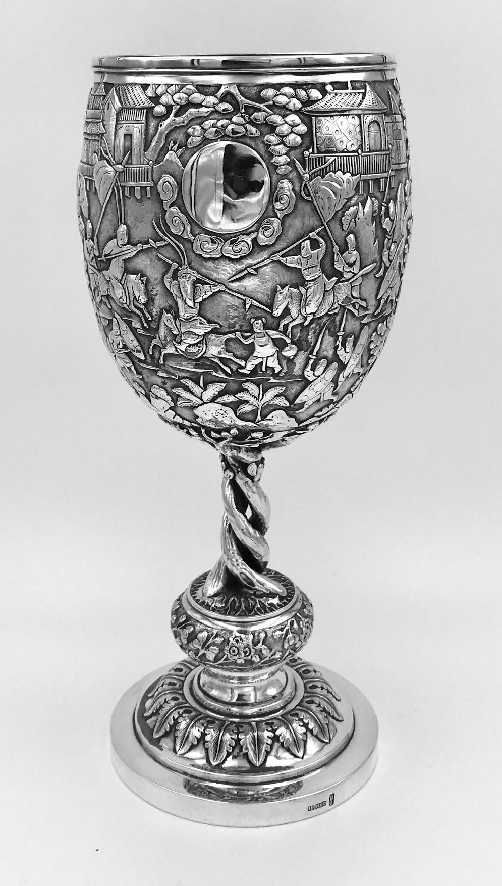 An exceptional and large Chinese silver goblet decorated with detailed scenes of battle and court and dating from circa 1875. It has the mark of the Shanghai firm of Luen Wo, and also has the artisan mark of Jiang Sheng.