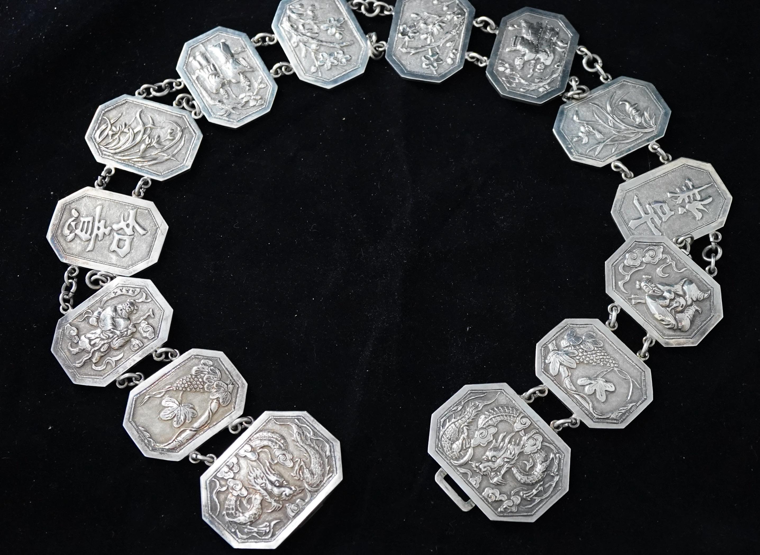 Chinese export silver ladies belt in fine repousse technique. The belt has a two-piece buckle and 12 medallions in 6 different patterns. The belt is 26 3/4