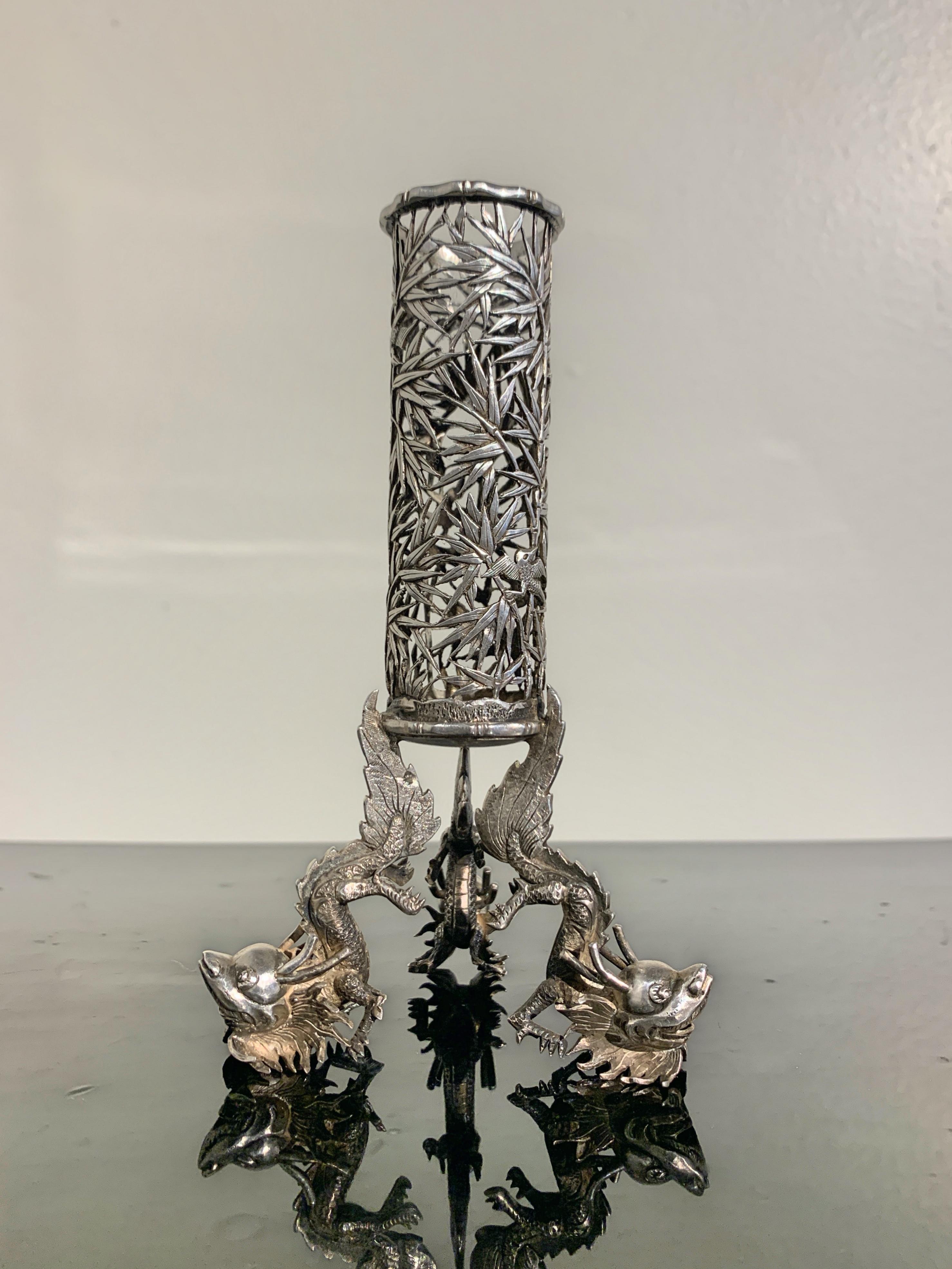 A wonderful Chinese export silver spill vase or bud vase with bamboo and dragon motifs, by Luen Wo, late 19th or early 20th century, circa 1900, China.

The Chinese export silver spill vase, or perhaps bud vase, is supported on three feet worked