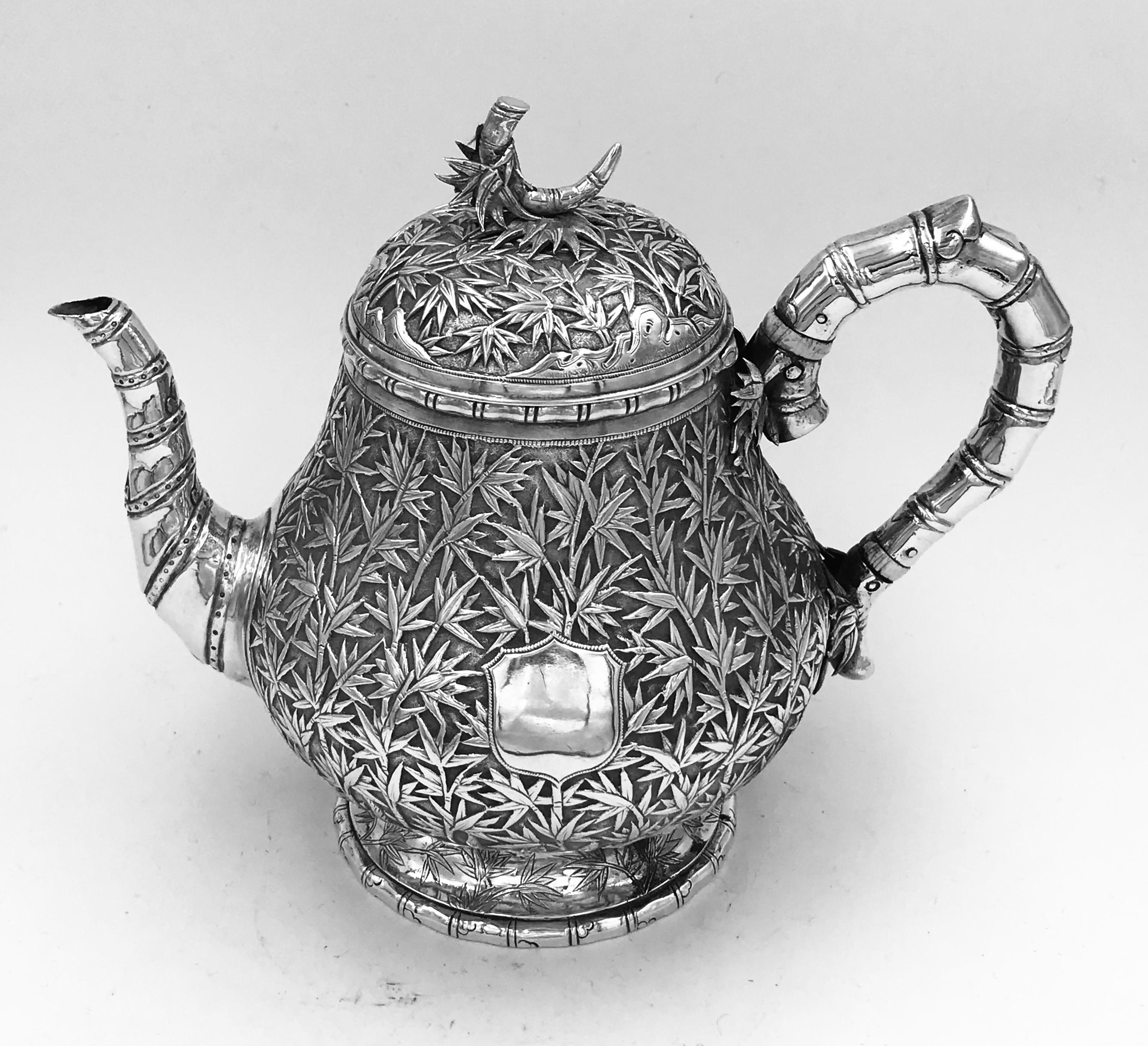 A Chinese Export Silver Teapot, circa 1865, profusely decorated with bamboo and with a vacant shield-shaped cartouche. There is a retailer mark of a Lombardic 