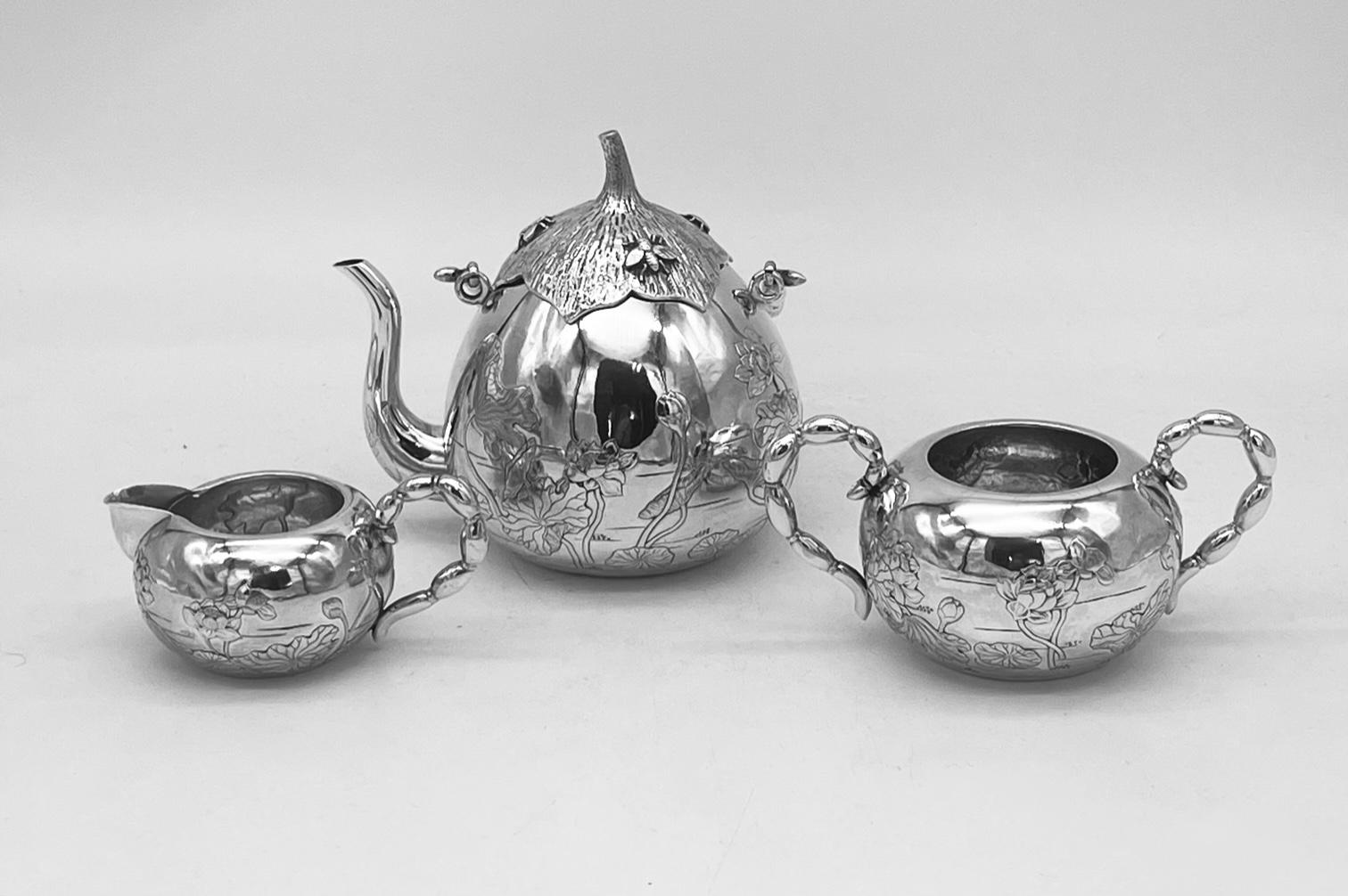 A beautiful and rare Chinese Export silver 3-piece teaset, the teapot in the form of an aubergine or eggplant, with three insects sitting on the removable cover. Each piece is embossed and chased with flowers, and the teapot has a swing handle. The